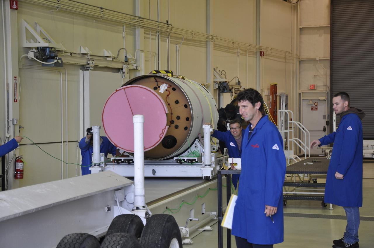 VANDENBERG AIR FORCE BASE, Calif. -- Orbital Sciences Corp. technicians prepare to move the first, second and third stages of the Pegasus XL rocket that will launch the Nuclear Spectroscopic Telescope Array NuSTAR to orbit from the west high bay to the east high bay of Building 1555 at Vandenberg Air Force Base in California. The move will allow technicians to process the spacecraft and fairing in the clean rooms of the east high bay before attaching it to the rocket. After the rocket and spacecraft are processed at Vandenberg, they will be flown on the Orbital Sciences' L-1011 carrier aircraft to the Ronald Reagan Ballistic Missile Defense Test Site located at the Pacific Ocean’s Kwajalein Atoll for launch. The high-energy X-ray telescope will conduct a census for black holes, map radioactive material in young supernovae remnants, and study the origins of cosmic rays and the extreme physics around collapsed stars. Photo credit: NASA/Randy Beaudoin, VAFB