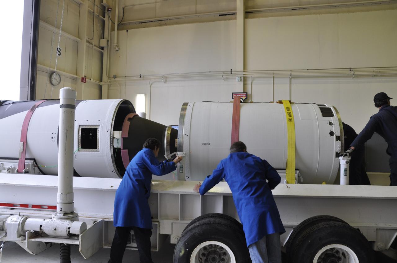 VANDENBERG AIR FORCE BASE, Calif. -- Orbital Sciences Corp. technicians prepare to move the first, second and third stages of the Pegasus XL rocket that will launch the Nuclear Spectroscopic Telescope Array NuSTAR to orbit from the west high bay to the east high bay of Building 1555 at Vandenberg Air Force Base in California. The move will allow technicians to process the spacecraft and fairing in the clean rooms of the east high bay before attaching it to the rocket. After the rocket and spacecraft are processed at Vandenberg, they will be flown on the Orbital Sciences' L-1011 carrier aircraft to the Ronald Reagan Ballistic Missile Defense Test Site located at the Pacific Ocean’s Kwajalein Atoll for launch. The high-energy X-ray telescope will conduct a census for black holes, map radioactive material in young supernovae remnants, and study the origins of cosmic rays and the extreme physics around collapsed stars. Photo credit: NASA/Randy Beaudoin, VAFB