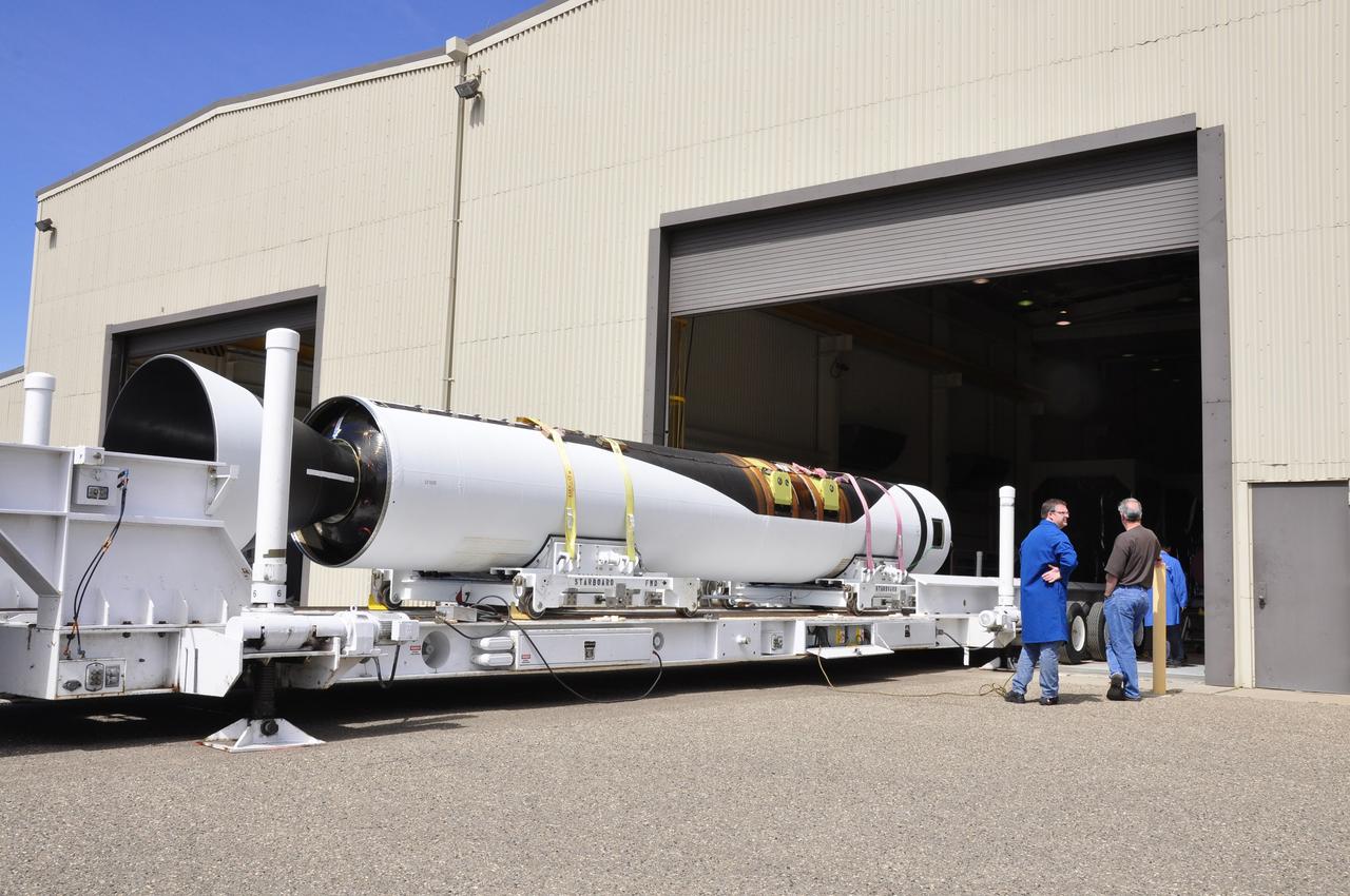 VANDENBERG AIR FORCE BASE, Calif. -- The first, second and third stages of the Orbital Sciences Corp. Pegasus XL rocket that will launch the Nuclear Spectroscopic Telescope Array NuSTAR to orbit are moved from the west high bay to the east high bay of Building 1555 at Vandenberg Air Force Base in California. The move will allow technicians to process the spacecraft and fairing in the clean rooms of the east high bay before attaching it to the rocket.          After the rocket and spacecraft are processed at Vandenberg, they will be flown on the Orbital Sciences' L-1011 carrier aircraft to the Ronald Reagan Ballistic Missile Defense Test Site located at the Pacific Ocean’s Kwajalein Atoll for launch. The high-energy X-ray telescope will conduct a census for black holes, map radioactive material in young supernovae remnants, and study the origins of cosmic rays and the extreme physics around collapsed stars. Photo credit: NASA/Randy Beaudoin, VAFB