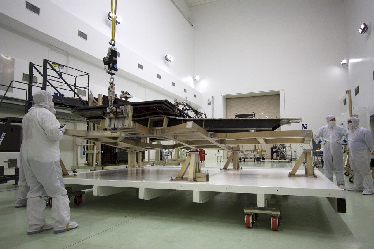 CAPE CANAVERAL, Fla. -- Technicians in the Astrotech payload processing facility in Titusville, Fla., prepare to unfurl solar array No. 1 with a magnetometer boom that will help power NASA's Juno spacecraft on a mission to Jupiter. Power-generating panels on three sets of solar arrays will extend outward from Juno’s hexagonal body, giving the overall spacecraft a span of more than 66 feet in order to operate at such a great distance from the sun. Juno is scheduled to launch aboard an Atlas V rocket from Cape Canaveral, Fla., on Aug. 5, 2011, reaching Jupiter in July 2016. The spacecraft will orbit the giant planet more than 30 times, skimming to within 3,000 miles above its cloud tops, for about one year. With its suite of science instruments, the spacecraft will investigate the existence of a solid planetary core, map Jupiter's intense magnetic field, measure the amount of water and ammonia in the deep atmosphere, and observe the planet's auroras. For more information visit, www.nasa.gov/juno. Photo credit: NASA/Jack Pfaller