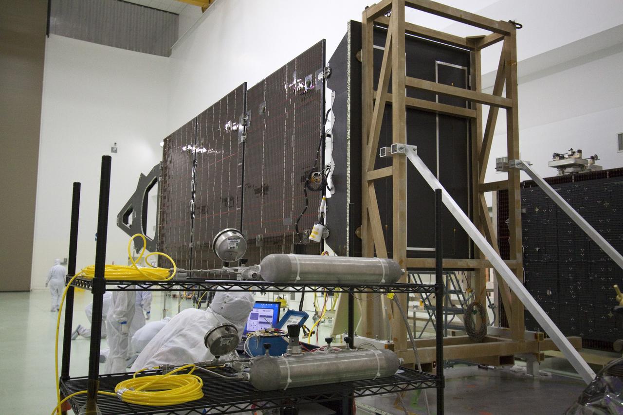 CAPE CANAVERAL, Fla. -- Technicians in the Astrotech payload processing facility in Titusville, Fla., check out solar array No. 1 with a magnetometer boom that will help power NASA's Juno spacecraft on a mission to Jupiter. Power-generating panels on three sets of solar arrays will extend outward from Juno’s hexagonal body, giving the overall spacecraft a span of more than 66 feet in order to operate at such a great distance from the sun. Juno is scheduled to launch aboard an Atlas V rocket from Cape Canaveral, Fla., on Aug. 5, 2011, reaching Jupiter in July 2016. The spacecraft will orbit the giant planet more than 30 times, skimming to within 3,000 miles above its cloud tops, for about one year. With its suite of science instruments, the spacecraft will investigate the existence of a solid planetary core, map Jupiter's intense magnetic field, measure the amount of water and ammonia in the deep atmosphere, and observe the planet's auroras. For more information visit, www.nasa.gov/juno. Photo credit: NASA/Jack Pfaller