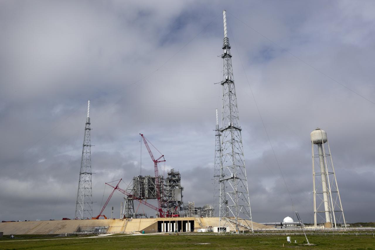 Cape Canaveral, Fla. -- A large crane dismantles the next section of the fixed service structure (FSS) on Launch Pad 39B at NASA's Kennedy Space Center in Florida. Work to remove the rotating service structure (RSS) also continues at the pad. The FSS and RSS were designed to support the unique needs of the Space Shuttle Program. In 2009, the pad was no longer needed for the shuttle program, so it is being restructured for future use. Its new design will feature a "clean pad" for rockets to come with their own launcher, making it more versatile for a number of vehicles. The new lightning protection system, which was in place for the October 2009 launch of Ares I-X, will remain. For information on NASA's future plans, visit www.nasa.gov. Photo credit: NASA/Dimitri Gerondidakis