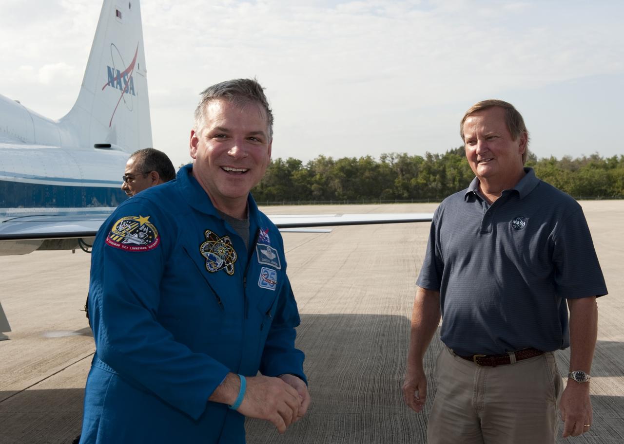 CAPE CANAVERAL, Fla. -- Shuttle Launch Director Mike Leinbach, right, is on hand to greet STS-134 Pilot Greg H. Johnson who arrived on the Shuttle Landing Facility at NASA's Kennedy Space Center in Florida aboard a T-38 jet. While at Kennedy, space shuttle Endeavour's crew will participate in a launch countdown dress rehearsal called the Terminal Countdown Demonstration Test (TCDT) and related training in preparation for the upcoming STS-134 mission. Endeavour and its six STS-134 crew members will deliver the Express Logistics Carrier-3, Alpha Magnetic Spectrometer-2 (AMS), a high-pressure gas tank, additional spare parts for the Dextre robotic helper and micrometeoroid debris shields to the International Space Station. This will be the final spaceflight for Endeavour. Launch is targeted for April 19 at 7:48 p.m. EDT. For more information visit, www.nasa.gov/mission_pages/shuttle/shuttlemissions/sts134/index.html. Photo credit: NASA/Kim Shiflett