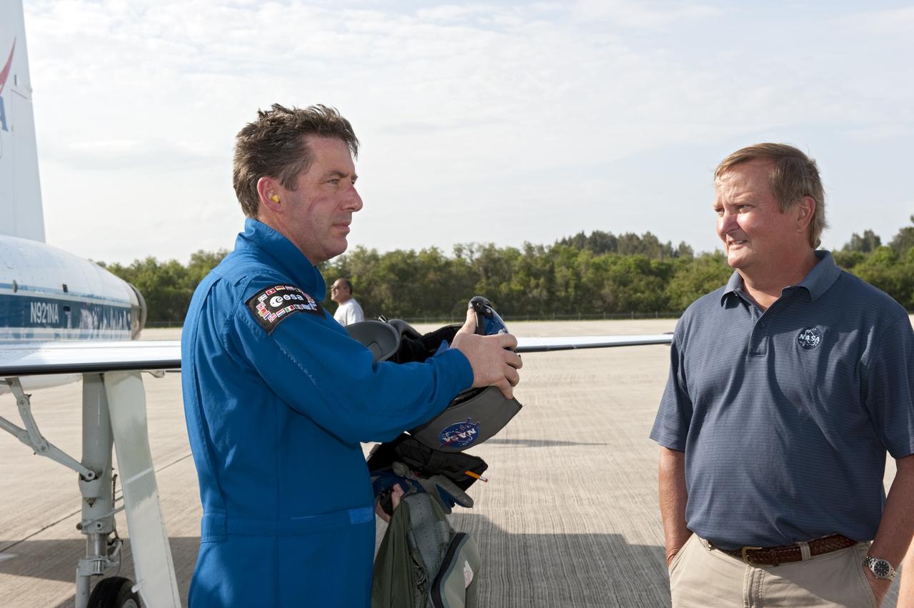 CAPE CANAVERAL, Fla. -- Shuttle Launch Director Mike Leinbach, right, is on hand to greet STS-134 Mission Specialist Roberto Vittori, with the European Space Agency, who arrived on the Shuttle Landing Facility at NASA's Kennedy Space Center in Florida aboard a T-38 jet. While at Kennedy, space shuttle Endeavour's crew will participate in a launch countdown dress rehearsal called the Terminal Countdown Demonstration Test (TCDT) and related training in preparation for the upcoming STS-134 mission. Endeavour and its six STS-134 crew members will deliver the Express Logistics Carrier-3, Alpha Magnetic Spectrometer-2 (AMS), a high-pressure gas tank, additional spare parts for the Dextre robotic helper and micrometeoroid debris shields to the International Space Station. This will be the final spaceflight for Endeavour. Launch is targeted for April 19 at 7:48 p.m. EDT. For more information visit, www.nasa.gov/mission_pages/shuttle/shuttlemissions/sts134/index.html. Photo credit: NASA/Kim Shiflett