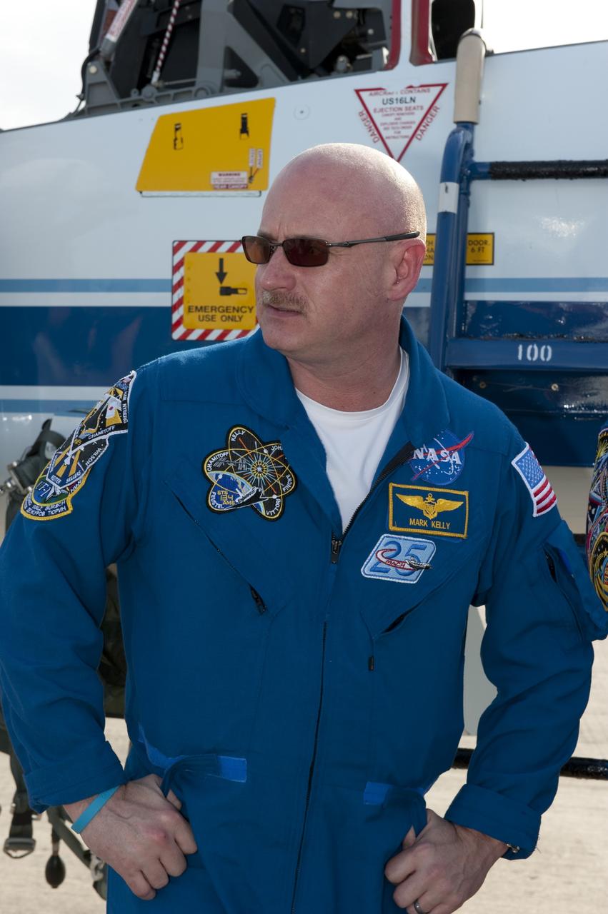 CAPE CANAVERAL, Fla. -- STS-134 Commander Mark Kelly stands in front of a T-38 jet on the Shuttle Landing Facility at NASA's Kennedy Space Center in Florida. While at Kennedy, space shuttle Endeavour's crew will participate in a launch countdown dress rehearsal called the Terminal Countdown Demonstration Test (TCDT) and related training in preparation for the upcoming STS-134 mission.          Endeavour and its six STS-134 crew members will deliver the Express Logistics Carrier-3, Alpha Magnetic Spectrometer-2 (AMS), a high-pressure gas tank, additional spare parts for the Dextre robotic helper and micrometeoroid debris shields to the International Space Station. This will be the final spaceflight for Endeavour. Launch is targeted for April 19 at 7:48 p.m. EDT. For more information visit, www.nasa.gov/mission_pages/shuttle/shuttlemissions/sts134/index.html. Photo credit: NASA/Kim Shiflett