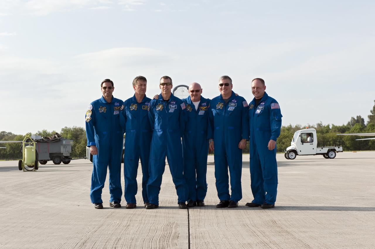 CAPE CANAVERAL, Fla. -- Space shuttle Endeavour's STS-134 crew members pose for a group photo on the Shuttle Landing Facility at NASA's Kennedy Space Center in Florida. While at Kennedy, Endeavour's crew will participate in a launch countdown dress rehearsal called the Terminal Countdown Demonstration Test (TCDT) and related training in preparation for the upcoming STS-134 mission. From left, are Mission Specialists Greg Chamitoff, European Space Agency astronaut Roberto Vittori, Andrew Feustel, Commander Mark Kelly, Pilot Greg H. Johnson, and Mission Specialist Michael Fincke. Endeavour and its six STS-134 crew members will deliver the Express Logistics Carrier-3, Alpha Magnetic Spectrometer-2 (AMS), a high-pressure gas tank, additional spare parts for the Dextre robotic helper and micrometeoroid debris shields to the International Space Station. This will be the final spaceflight for Endeavour. Launch is targeted for April 19 at 7:48 p.m. EDT. For more information visit, www.nasa.gov/mission_pages/shuttle/shuttlemissions/sts134/index.html. Photo credit: NASA/Kim Shiflett
