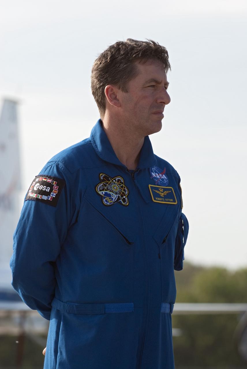CAPE CANAVERAL, Fla. -- STS-134 Mission Specialist Roberto Vittori, with the European Space Agency, listens to Commander Mark Kelly address the media on the Shuttle Landing Facility at NASA's Kennedy Space Center in Florida. While at Kennedy, space shuttle Endeavour's crew will participate in a launch countdown dress rehearsal called the Terminal Countdown Demonstration Test (TCDT) and related training in preparation for the upcoming STS-134 mission.           Endeavour and its six STS-134 crew members will deliver the Express Logistics Carrier-3, Alpha Magnetic Spectrometer-2 (AMS), a high-pressure gas tank, additional spare parts for the Dextre robotic helper and micrometeoroid debris shields to the International Space Station. This will be the final spaceflight for Endeavour. Launch is targeted for April 19 at 7:48 p.m. EDT. For more information visit, www.nasa.gov/mission_pages/shuttle/shuttlemissions/sts134/index.html. Photo credit: NASA/Kim Shiflett