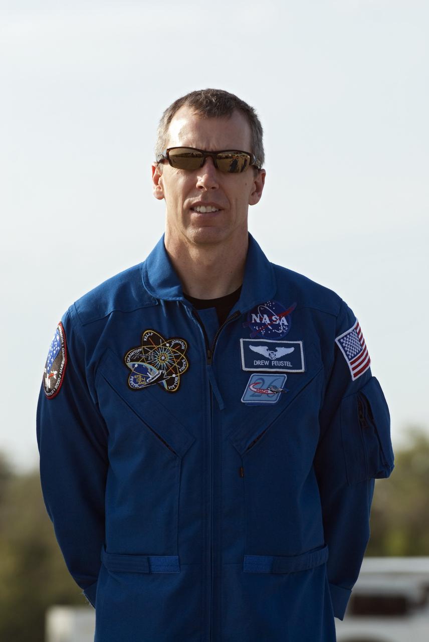 CAPE CANAVERAL, Fla. -- STS-134 Mission Specialist Andrew Feustel listens to Commander Mark Kelly address the media on the Shuttle Landing Facility at NASA's Kennedy Space Center in Florida. While at Kennedy, space shuttle Endeavour's crew will participate in a launch countdown dress rehearsal called the Terminal Countdown Demonstration Test (TCDT) and related training in preparation for the upcoming STS-134 mission.       Endeavour and its six STS-134 crew members will deliver the Express Logistics Carrier-3, Alpha Magnetic Spectrometer-2 (AMS), a high-pressure gas tank, additional spare parts for the Dextre robotic helper and micrometeoroid debris shields to the International Space Station. This will be the final spaceflight for Endeavour. Launch is targeted for April 19 at 7:48 p.m. EDT. For more information visit, www.nasa.gov/mission_pages/shuttle/shuttlemissions/sts134/index.html. Photo credit: NASA/Kim Shiflett