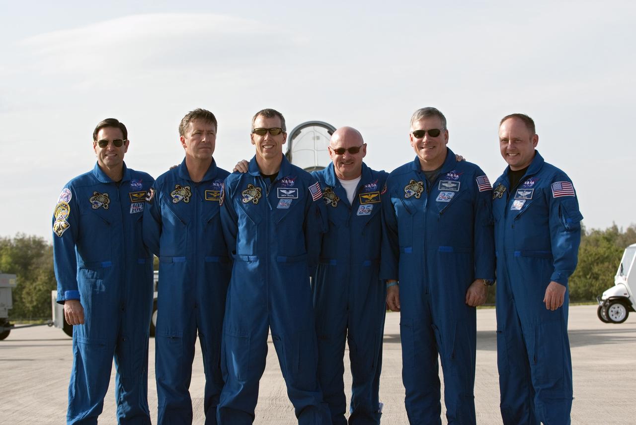 CAPE CANAVERAL, Fla. -- Space shuttle Endeavour's STS-134 crew members pose for a group photo on the Shuttle Landing Facility at NASA's Kennedy Space Center in Florida. While at Kennedy, Endeavour's crew will participate in a launch countdown dress rehearsal called the Terminal Countdown Demonstration Test (TCDT) and related training in preparation for the upcoming STS-134 mission. From left, are Mission Specialists Greg Chamitoff, European Space Agency astronaut Roberto Vittori, Andrew Feustel, Commander Mark Kelly, Pilot Greg H. Johnson, and Mission Specialist Michael Fincke. Endeavour and its six STS-134 crew members will deliver the Express Logistics Carrier-3, Alpha Magnetic Spectrometer-2 (AMS), a high-pressure gas tank, additional spare parts for the Dextre robotic helper and micrometeoroid debris shields to the International Space Station. This will be the final spaceflight for Endeavour. Launch is targeted for April 19 at 7:48 p.m. EDT. For more information visit, www.nasa.gov/mission_pages/shuttle/shuttlemissions/sts134/index.html. Photo credit: NASA/Kim Shiflett