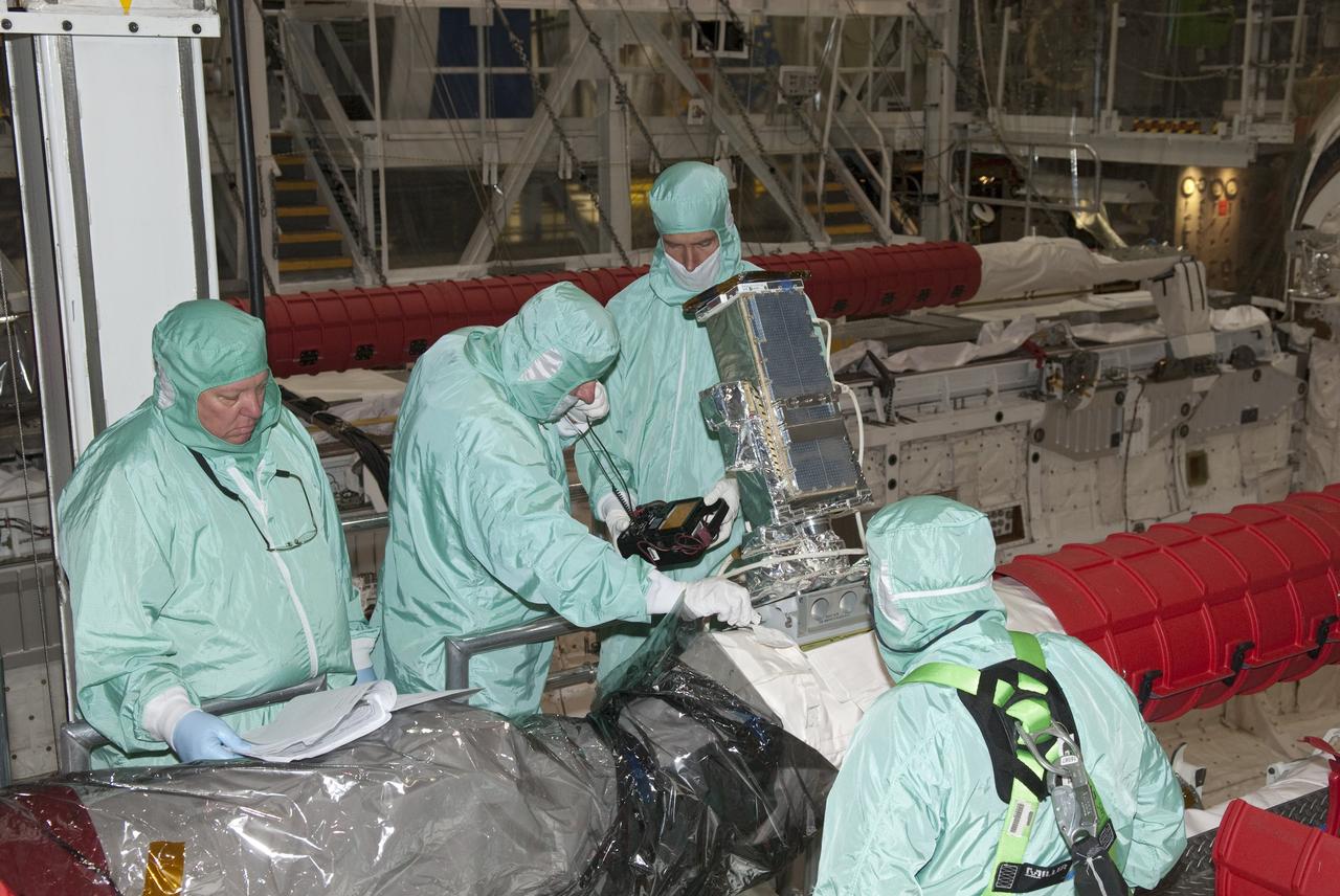 CAPE CANAVERAL, Fla. - In Orbiter Processing Facility-1 at NASA's Kennedy Space Center in Florida, technicians install an elbow camera onto the robotic arm inside shuttle Atlantis' payload bay.            Atlantis is being prepared for the STS-135 mission, which will deliver the Raffaello multipurpose logistics module packed with supplies, logistics and spare parts to the International Space Station. STS-135 is targeted to launch June 28, and will be the last spaceflight for the Space Shuttle Program. Photo credit: NASA/Jim Grossmann