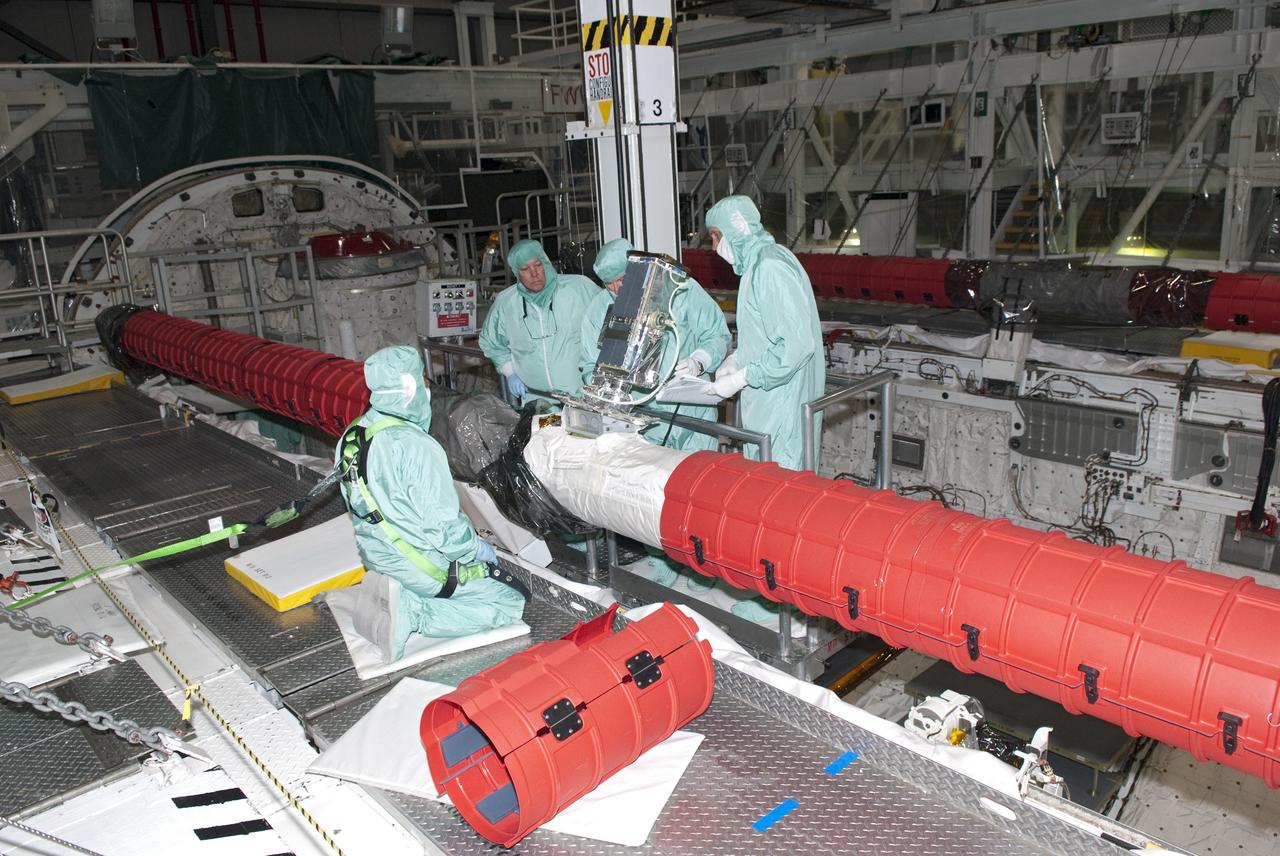 CAPE CANAVERAL, Fla. - In Orbiter Processing Facility-1 at NASA's Kennedy Space Center in Florida, technicians install an elbow camera onto the robotic arm inside shuttle Atlantis' payload bay.            Atlantis is being prepared for the STS-135 mission, which will deliver the Raffaello multipurpose logistics module packed with supplies, logistics and spare parts to the International Space Station. STS-135 is targeted to launch June 28, and will be the last spaceflight for the Space Shuttle Program. Photo credit: NASA/Jim Grossmann