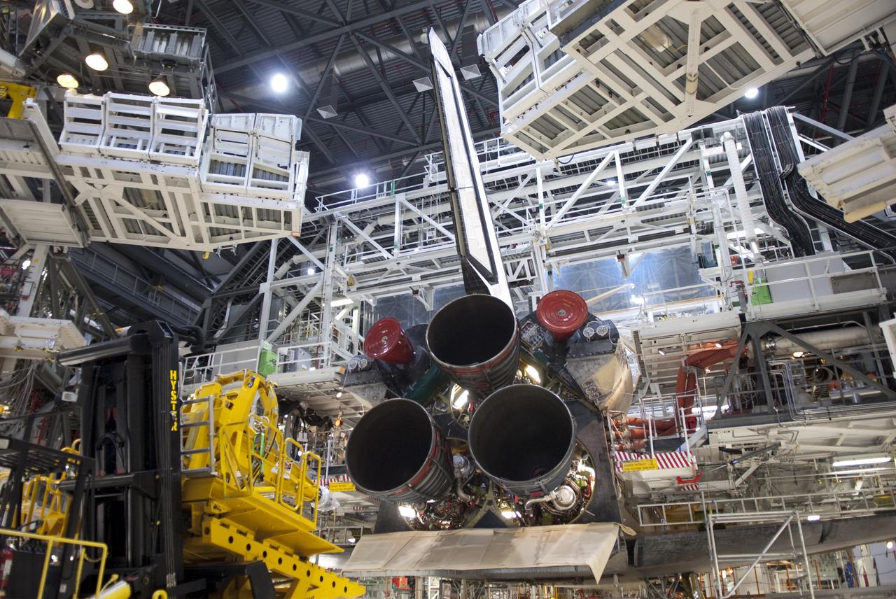 CAPE CANAVERAL, Fla. -- The specialized engine installer is moved near space shuttle Discovery as technicians prepare to remove the three main engines from the orbiter. The work is taking place in Orbiter Processing Facility-2 at NASA's Kennedy Space Center in Florida. The transition and retirement processing is expected to help rocket designers build next-generation spacecraft and prepare the shuttle for display. Photo credit: NASA/Jim Grossmann