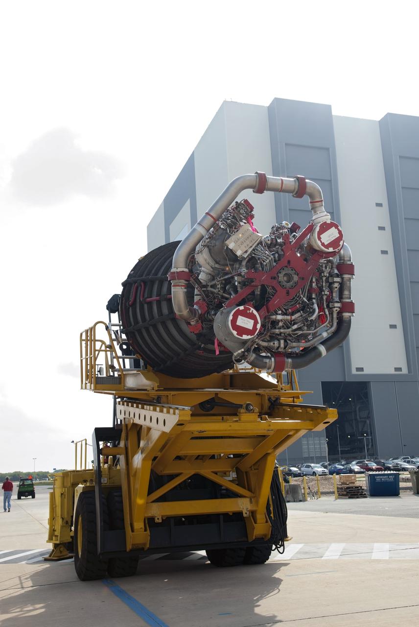 CAPE CANAVERAL, Fla. -- A heavy forklift with its specialized engine installer hold one of the main engines taken from space shuttle Discovery. The forklift is driving the engine from Orbiter Processing Facility-2 at NASA's Kennedy Space Center in Florida to the center's Space Shuttle Main Engine Processing Facility. The transition and retirement processing is expected to help rocket designers build next-generation spacecraft and prepare the shuttle for display. Photo credit: NASA/Jim Grossmann
