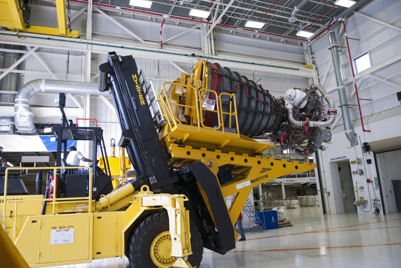 CAPE CANAVERAL, Fla. -- A heavy forklift with its specialized engine installer carries one of the main engines taken from space shuttle Discovery into the Space Shuttle Main Engine Processing Facility at NASA's Kennedy Space Center in Florida. The transition and retirement processing is expected to help rocket designers build next-generation spacecraft and prepare the shuttle for display. Photo credit: NASA/Jim Grossmann