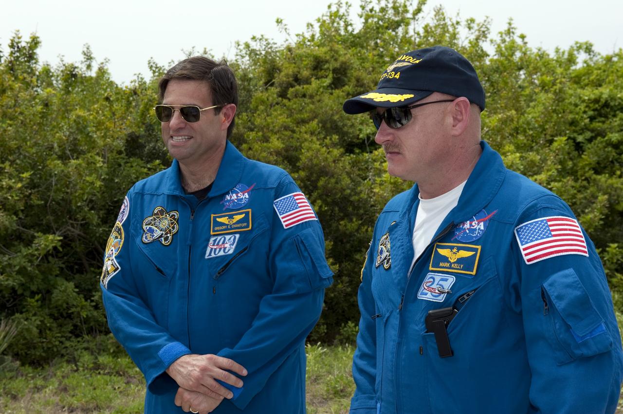 CAPE CANAVERAL, Fla. - At NASA's Kennedy Space Center in Florida, STS-134 Mission Specialist Greg Chamitoff, left, and Commander Mark Kelly take a break from training on the M113 armored personnel carrier at NASA's Kennedy Space Center in Florida. An M113 is kept at the foot of the launch pad in case an emergency exit from the pad is needed and every shuttle crew is trained on driving the vehicle before launch. Endeavour's six crew members are at Kennedy for the launch countdown dress rehearsal called the Terminal Countdown Demonstration Test (TCDT) and related training. Targeted to launch April 19 at 7:48 p.m. EDT, they will deliver the Express Logistics Carrier-3, Alpha Magnetic Spectrometer-2 (AMS), a high-pressure gas tank, additional spare parts for the Dextre robotic helper and micrometeoroid debris shields to the space station. This will be the final spaceflight for Endeavour. For more information visit, www.nasa.gov/mission_pages/shuttle/shuttlemissions/sts134/index.html. Photo credit: NASA/Kim Shiflett
