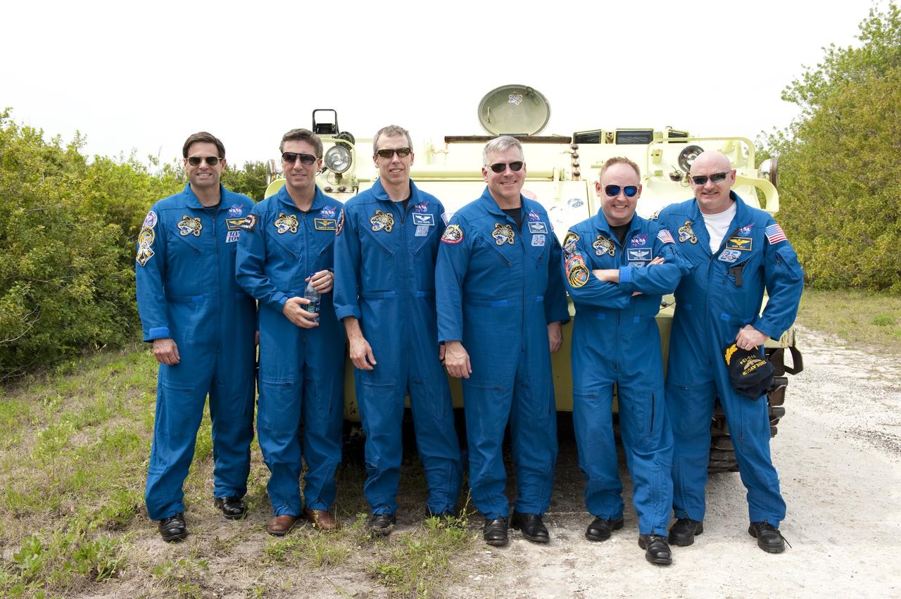 CAPE CANAVERAL, Fla. - Space shuttle Endeavour's STS-134 crew members pose for a group photo in front of an M113 armored personnel carrier at NASA's Kennedy Space Center in Florida. An M113 is kept at the foot of the launch pad in case an emergency exit from the pad is needed and every shuttle crew is trained on driving the vehicle before launch. From left, are Mission Specialists Greg Chamitoff, European Space Agency astronaut Roberto Vittori and Andrew Feustel, Pilot Greg H. Johnson, Mission Specialist Michael Fincke, and Commander Mark Kelly. Endeavour's six crew members are at Kennedy for the launch countdown dress rehearsal called the Terminal Countdown Demonstration Test (TCDT) and related training. Targeted to launch April 19 at 7:48 p.m. EDT, they will deliver the Express Logistics Carrier-3, Alpha Magnetic Spectrometer-2 (AMS), a high-pressure gas tank, additional spare parts for the Dextre robotic helper and micrometeoroid debris shields to the space station. This will be the final spaceflight for Endeavour. For more information visit, www.nasa.gov/mission_pages/shuttle/shuttlemissions/sts134/index.html. Photo credit: NASA/Kim Shiflett