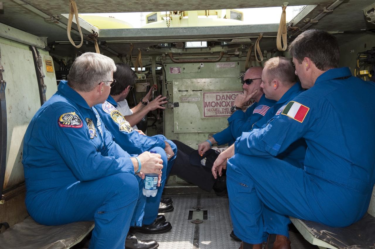 CAPE CANAVERAL, Fla. - At NASA's Kennedy Space Center in Florida, the crew members of space shuttle Endeavour's STS-134 mission experience the interior of an M113 armored personnel carrier. An M113 is kept at the foot of the launch pad in case an emergency exit from the pad is needed and every shuttle crew is trained on driving the vehicle before launch. From left is Pilot Greg H. Johnson, Mission Specialist Greg Chamitoff, Battalion Chief David Seymour (partially obscured), Commander Mark Kelly, Mission Specialists Mike Fincke and European Space Agency astronaut Roberto Vittori. Space shuttle Endeavour's six crew members are at Kennedy for the launch countdown dress rehearsal called the Terminal Countdown Demonstration Test (TCDT) and related training. Targeted to launch April 19 at 7:48 p.m. EDT, they will deliver the Express Logistics Carrier-3, Alpha Magnetic Spectrometer-2 (AMS), a high-pressure gas tank, additional spare parts for the Dextre robotic helper and micrometeoroid debris shields to the space station. This will be the final spaceflight for Endeavour. For more information visit, www.nasa.gov/mission_pages/shuttle/shuttlemissions/sts134/index.html. Photo credit: NASA/Kim Shiflett