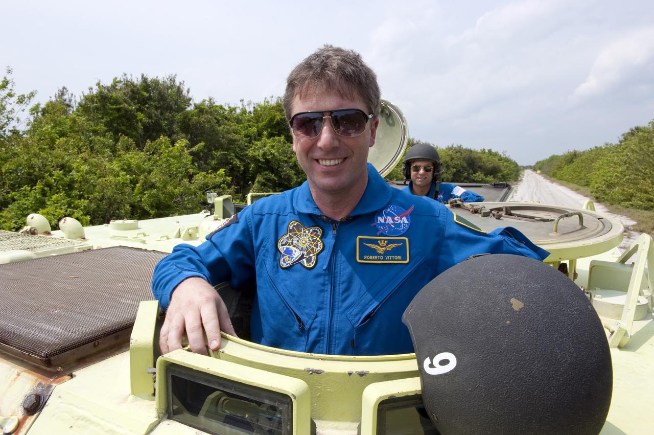 CAPE CANAVERAL, Fla. - Astronaut and Mission Specialist Roberto Vittori with the European Space Agency takes time out from driving practice of the M113 armored personnel carrier to pose for a photo at NASA's Kennedy Space Center in Florida. An M113 is kept at the foot of the launch pad in case an emergency exit from the pad is needed and every shuttle crew is trained on driving the vehicle before launch. Space shuttle Endeavour's six crew members are at Kennedy for the launch countdown dress rehearsal called the Terminal Countdown Demonstration Test (TCDT) and related training. Targeted to launch April 19 at 7:48 p.m. EDT, they will deliver the Express Logistics Carrier-3, Alpha Magnetic Spectrometer-2 (AMS), a high-pressure gas tank, additional spare parts for the Dextre robotic helper and micrometeoroid debris shields to the space station. This will be the final spaceflight for Endeavour. For more information visit, www.nasa.gov/mission_pages/shuttle/shuttlemissions/sts134/index.html. Photo credit: NASA/Kim Shiflett
