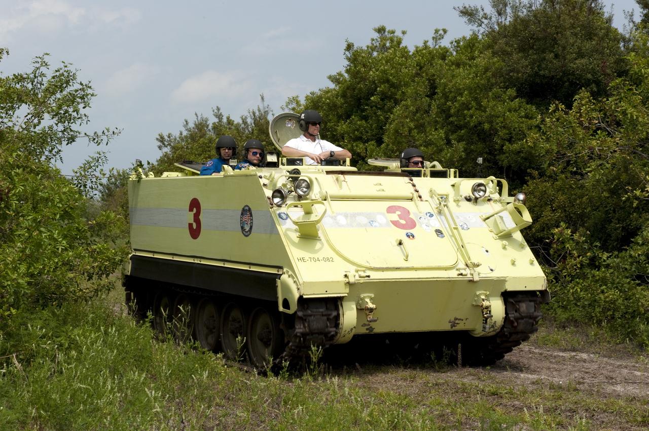 CAPE CANAVERAL, Fla. - Battalion Chief David Seymour provides supervision while space shuttle Endeavour's STS-134 crew members participate in M113 armored personnel carrier training at NASA's Kennedy Space Center in Florida. An M113 is kept at the foot of the launch pad in case an emergency exit from the pad is needed and every shuttle crew is trained on driving the vehicle before launch. Space shuttle Endeavour's six crew members are at Kennedy for the launch countdown dress rehearsal called the Terminal Countdown Demonstration Test (TCDT) and related training. Targeted to launch April 19 at 7:48 p.m. EDT, they will deliver the Express Logistics Carrier-3, Alpha Magnetic Spectrometer-2 (AMS), a high-pressure gas tank, additional spare parts for the Dextre robotic helper and micrometeoroid debris shields to the space station. This will be the final spaceflight for Endeavour. For more information visit, www.nasa.gov/mission_pages/shuttle/shuttlemissions/sts134/index.html. Photo credit: NASA/Kim Shiflett