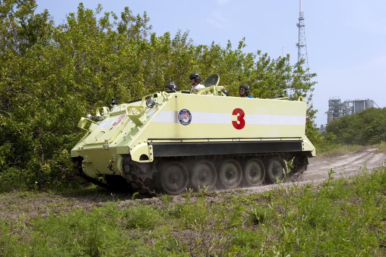 CAPE CANAVERAL, Fla. - Battalion Chief David Seymour provides supervision while space shuttle Endeavour's STS-134 crew members participate in M113 armored personnel carrier training near Launch Pad 39B at NASA's Kennedy Space Center in Florida. An M113 is kept at the foot of the launch pad in case an emergency exit from the pad is needed and every shuttle crew is trained on driving the vehicle before launch. Space shuttle Endeavour's six crew members are at Kennedy for the launch countdown dress rehearsal called the Terminal Countdown Demonstration Test (TCDT) and related training. Targeted to launch April 19 at 7:48 p.m. EDT, they will deliver the Express Logistics Carrier-3, Alpha Magnetic Spectrometer-2 (AMS), a high-pressure gas tank, additional spare parts for the Dextre robotic helper and micrometeoroid debris shields to the space station. This will be the final spaceflight for Endeavour. For more information visit, www.nasa.gov/mission_pages/shuttle/shuttlemissions/sts134/index.html. Photo credit: NASA/Kim Shiflett