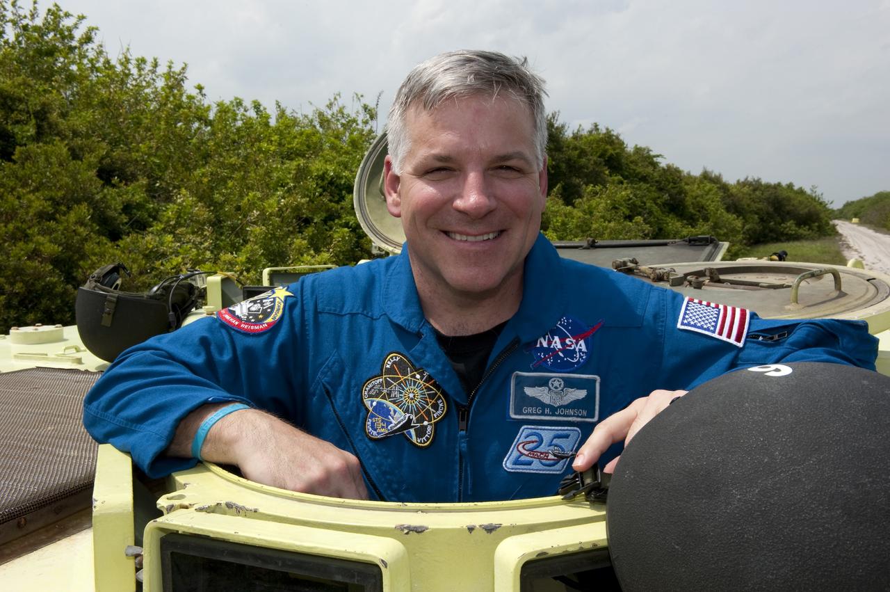 CAPE CANAVERAL, Fla. - STS-134 Pilot Greg H. Johnson takes time out from driving practice of the M113 armored personnel carrier to pose for a photo at NASA's Kennedy Space Center in Florida. An M113 is kept at the foot of the launch pad in case an emergency exit from the pad is needed and every shuttle crew is trained on driving the vehicle before launch. Space shuttle Endeavour's six crew members are at Kennedy for the launch countdown dress rehearsal called the Terminal Countdown Demonstration Test (TCDT) and related training. Targeted to launch April 19 at 7:48 p.m. EDT, they will deliver the Express Logistics Carrier-3, Alpha Magnetic Spectrometer-2 (AMS), a high-pressure gas tank, additional spare parts for the Dextre robotic helper and micrometeoroid debris shields to the space station. This will be the final spaceflight for Endeavour. For more information visit, www.nasa.gov/mission_pages/shuttle/shuttlemissions/sts134/index.html. Photo credit: NASA/Kim Shiflett