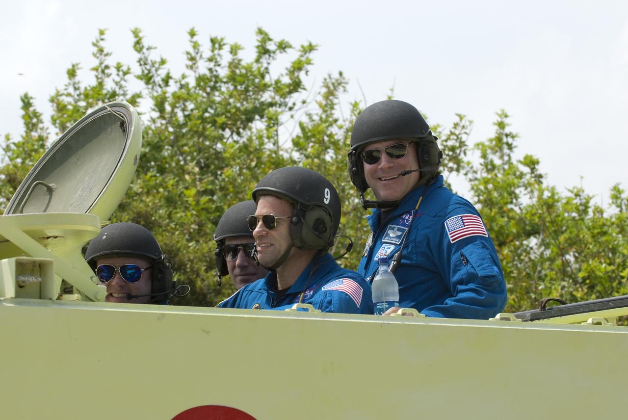 CAPE CANAVERAL, Fla. - At NASA's Kennedy Space Center in Florida, STS-134 Mission Specialist Greg Chamitoff practices driving an M113 armored personnel carrier. Mission Specialist Mike Fincke (left), astronaut Roberto Vittori with the European Space Agency and Pilot Greg H. Johnson enjoy the ride. An M113 is kept at the foot of the launch pad in case an emergency exit from the pad is needed and every shuttle crew is trained on driving the vehicle before launch. Space shuttle Endeavour's six crew members are at Kennedy for the launch countdown dress rehearsal called the Terminal Countdown Demonstration Test (TCDT) and related training. Targeted to launch April 19 at 7:48 p.m. EDT, they will deliver the Express Logistics Carrier-3, Alpha Magnetic Spectrometer-2 (AMS), a high-pressure gas tank, additional spare parts for the Dextre robotic helper and micrometeoroid debris shields to the space station. This is the final scheduled spaceflight for Endeavour. For more information visit, www.nasa.gov/mission_pages/shuttle/shuttlemissions/sts134/index.html. Photo credit: NASA/Kim Shiflett
