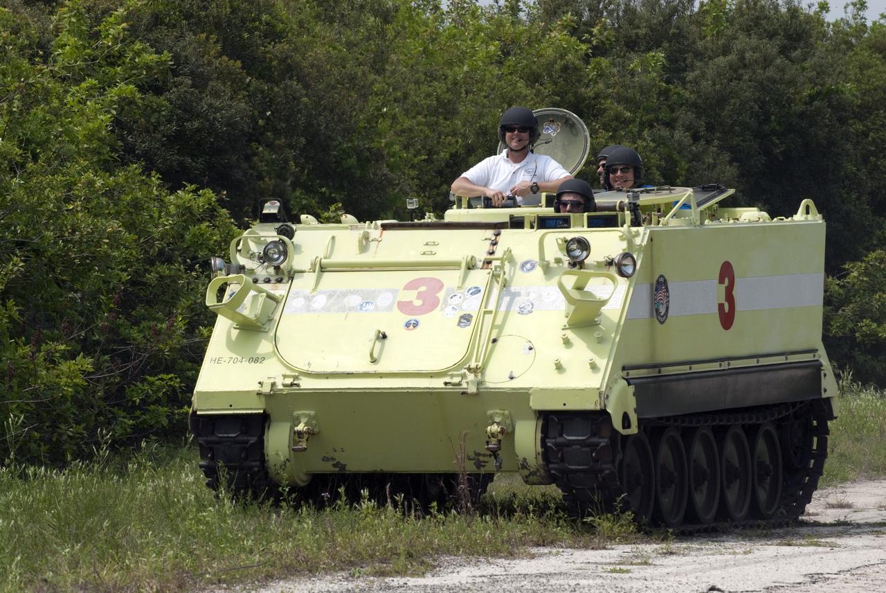 CAPE CANAVERAL, Fla. - Battalion Chief David Seymour stops for a photo opportunity with space shuttle Endeavour's STS-134 crew members as they participate in M113 armored personnel carrier training at NASA's Kennedy Space Center in Florida. An M113 is kept at the foot of the launch pad in case an emergency exit from the pad is needed and every shuttle crew is trained on driving the vehicle before launch. Space shuttle Endeavour's six crew members are at Kennedy for the launch countdown dress rehearsal called the Terminal Countdown Demonstration Test (TCDT) and related training. Targeted to launch April 19 at 7:48 p.m. EDT, they will deliver the Express Logistics Carrier-3, Alpha Magnetic Spectrometer-2 (AMS), a high-pressure gas tank, additional spare parts for the Dextre robotic helper and micrometeoroid debris shields to the space station. This is the final scheduled spaceflight for Endeavour. For more information visit, www.nasa.gov/mission_pages/shuttle/shuttlemissions/sts134/index.html. Photo credit: NASA/Kim Shiflett