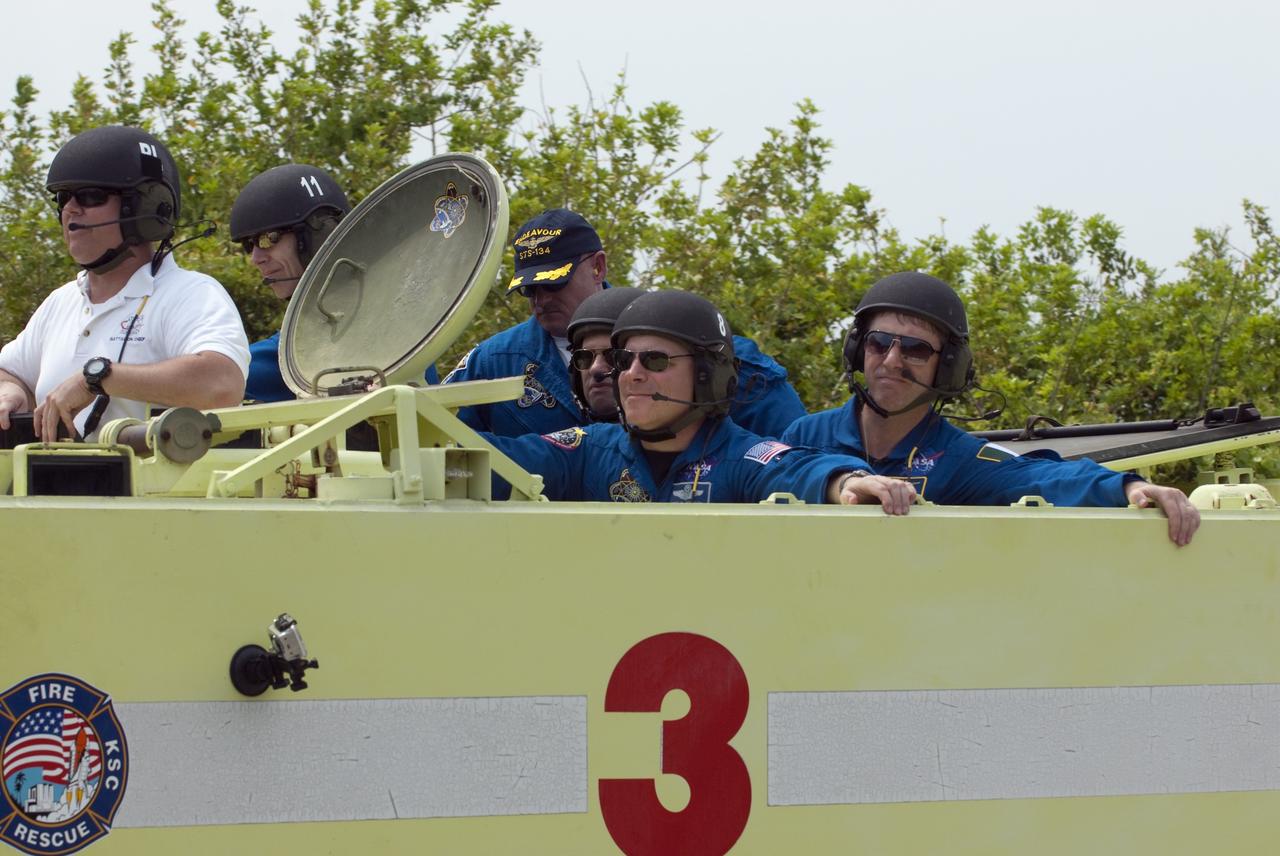 CAPE CANAVERAL, Fla. - Battalion Chief David Seymour provides supervision while space shuttle Endeavour's STS-134 crew members participate in M113 armored personnel carrier training at NASA's Kennedy Space Center in Florida. An M113 is kept at the foot of the launch pad in case an emergency exit from the pad is needed and every shuttle crew is trained on driving the vehicle before launch. Space shuttle Endeavour's six crew members are at Kennedy for the launch countdown dress rehearsal called the Terminal Countdown Demonstration Test (TCDT) and related training. Targeted to launch April 19 at 7:48 p.m. EDT, they will deliver the Express Logistics Carrier-3, Alpha Magnetic Spectrometer-2 (AMS), a high-pressure gas tank, additional spare parts for the Dextre robotic helper and micrometeoroid debris shields to the space station. This is the final scheduled spaceflight for Endeavour. For more information visit, www.nasa.gov/mission_pages/shuttle/shuttlemissions/sts134/index.html. Photo credit: NASA/Kim Shiflett