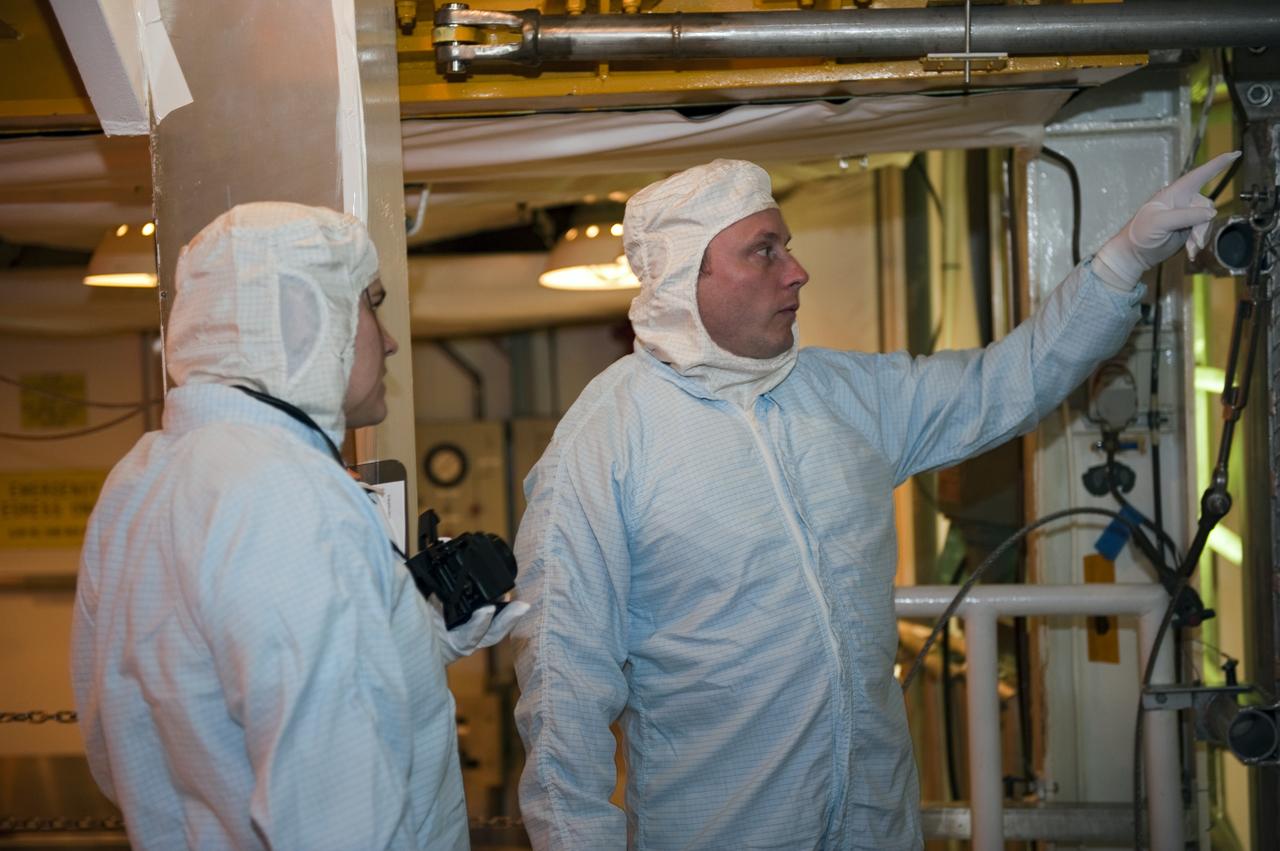 CAPE CANAVERAL, Fla. -- STS-134 Mission Specialist Michael Fincke, right, performs a walkdown of space shuttle Endeavour's payload bay with a shuttle technician. The Express Logistics Carrier-3 packed with spare parts and the Alpha Magnetic Spectrometer-2 (AMS) are inside the bay for the STS-134 mission to the International Space Station. Fincke and fellow Mission Specialists Greg Chamitoff and Andrew Feustel are the designated spacewalkers for the mission.        Endeavour's six crew members are at Kennedy for the launch countdown dress rehearsal called the Terminal Countdown Demonstration Test (TCDT) and related training. Endeavour is targeted to launch April 19 at 7:48 p.m. EDT on its final spaceflight mission. For more information visit, www.nasa.gov/mission_pages/shuttle/shuttlemissions/sts134/index.html. Photo credit: NASA/Kim Shiflett