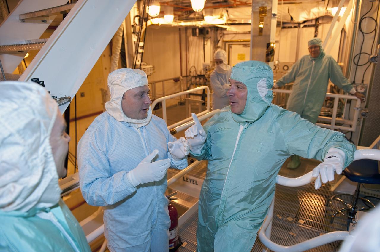 CAPE CANAVERAL, Fla. -- STS-134 Mission Specialist Michael Fincke, right, and Pilot Greg H. Johnson, center, perform a walkdown of space shuttle Endeavour's payload bay with shuttle technicians. The Express Logistics Carrier-3 packed with spare parts and the Alpha Magnetic Spectrometer-2 (AMS) are inside the bay for the STS-134 mission to the International Space Station.       Endeavour's six crew members are at Kennedy for the launch countdown dress rehearsal called the Terminal Countdown Demonstration Test (TCDT) and related training. Endeavour is targeted to launch April 19 at 7:48 p.m. EDT on its final spaceflight mission. For more information visit, www.nasa.gov/mission_pages/shuttle/shuttlemissions/sts134/index.html. Photo credit: NASA/Kim Shiflett