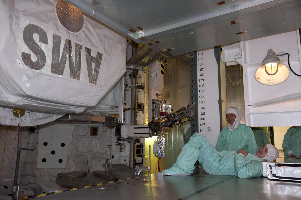 CAPE CANAVERAL, Fla. -- STS-134 Commander Mark Kelly, lying down, and Professor Sam Ting, Alpha Magnetic Spectrometer-2 (AMS) principal investigator at the Massachusetts Institute of Technology, perform a walkdown of space shuttle Endeavour's payload bay. The Express Logistics Carrier-3 packed with spare parts and the (AMS) are inside the bay for the STS-134 mission to the International Space Station.     Endeavour's six crew members are at Kennedy for the launch countdown dress rehearsal called the Terminal Countdown Demonstration Test (TCDT) and related training. Endeavour is targeted to launch April 19 at 7:48 p.m. EDT on its final spaceflight mission. For more information visit, www.nasa.gov/mission_pages/shuttle/shuttlemissions/sts134/index.html. Photo credit: NASA/Kim Shiflett