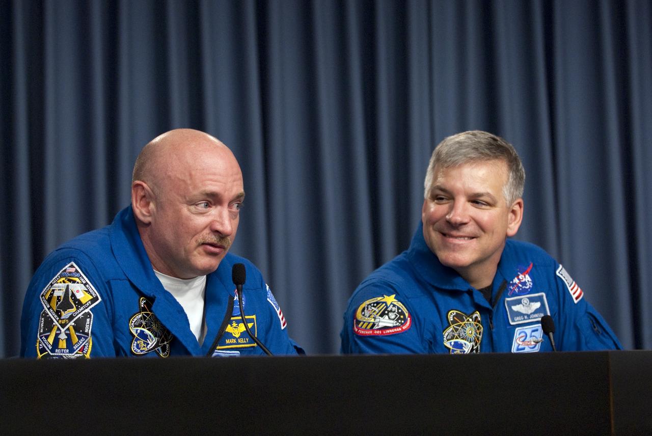 CAPE CANAVERAL, Fla. -- The STS-134 Commander Mark Kelly and Pilot Greg H. Johnson participate in a media question-and-answer session in the Press Site TV auditorium at NASA's Kennedy Space Center in Florida. The crew was scheduled to answer questions at Launch Pad 39A, where space shuttle Endeavour is awaiting liftoff, but severe storms associated with a frontal system passing over Central Florida brought the media event indoors.      Endeavour's six crew members are at Kennedy for the launch countdown dress rehearsal called the Terminal Countdown Demonstration Test (TCDT) and related training. Targeted to launch April 19 at 7:48 p.m. EDT, they will deliver the Express Logistics Carrier-3, Alpha Magnetic Spectrometer-2 (AMS), a high-pressure gas tank, additional spare parts for the Dextre robotic helper and micrometeoroid debris shields to the International Space Station. This is the final spaceflight for Endeavour. For more information visit, www.nasa.gov/mission_pages/shuttle/shuttlemissions/sts134/index.html. Photo credit: NASA/Kim Shiflett