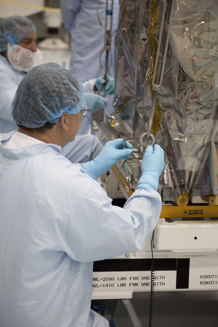 CAPE CANAVERAL, Fla. -- In the Space Station Processing Facility at NASA's Kennedy Space Center in Florida, technicians prepare to move a system that will investigate the potential for robotically refueling existing spacecraft in orbit into the Lightweight Multi-Purpose Experiment Support Structure Carrier (LMC). Called the Robotic Refueling Mission (RRM), the system is being processed to fly aboard space shuttle Atlantis in the LMC on the STS-135 mission to the International Space Station. Also going up will be the Raffaello multipurpose logistics module packed with supplies, logistics and spare parts. The mission also will return a failed ammonia pump module to help NASA better understand the failure mechanism and improve pump designs for future systems. STS-135, targeted to launch June 28, will be the 33rd flight of Atlantis, the 37th shuttle mission to the space station, and the 135th and final mission of NASA's Space Shuttle Program. For more information visit, www.nasa.gov/mission_pages/shuttle/shuttlemissions/sts135/index.html. Photo credit: NASA/Ben Smegelsky