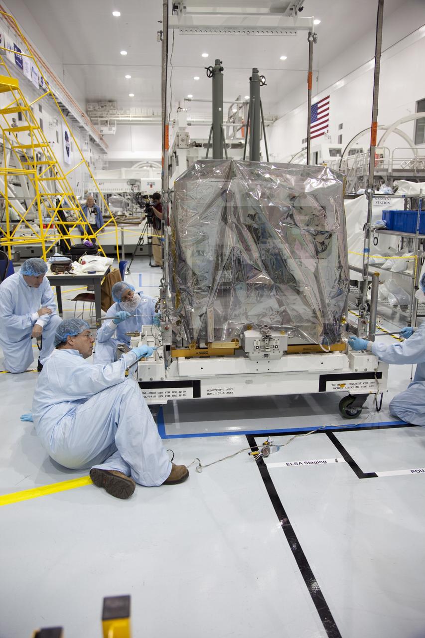 CAPE CANAVERAL, Fla. -- In the Space Station Processing Facility at NASA's Kennedy Space Center in Florida, technicians prepare to move a system that will investigate the potential for robotically refueling existing spacecraft in orbit into the Lightweight Multi-Purpose Experiment Support Structure Carrier (LMC). Called the Robotic Refueling Mission (RRM), the system is being processed to fly aboard space shuttle Atlantis in the LMC on the STS-135 mission to the International Space Station. Also going up will be the Raffaello multipurpose logistics module packed with supplies, logistics and spare parts. The mission also will return a failed ammonia pump module to help NASA better understand the failure mechanism and improve pump designs for future systems. STS-135, targeted to launch June 28, will be the 33rd flight of Atlantis, the 37th shuttle mission to the space station, and the 135th and final mission of NASA's Space Shuttle Program. For more information visit, www.nasa.gov/mission_pages/shuttle/shuttlemissions/sts135/index.html. Photo credit: NASA/Ben Smegelsky