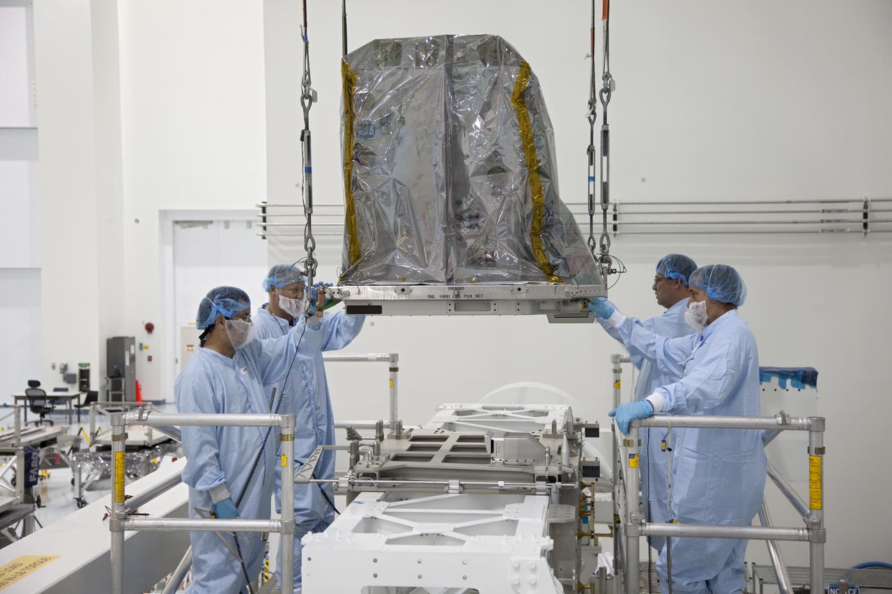 CAPE CANAVERAL, Fla. -- In the Space Station Processing Facility at NASA's Kennedy Space Center in Florida, technicians move a system that will investigate the potential for robotically refueling existing spacecraft in orbit into the Lightweight Multi-Purpose Experiment Support Structure Carrier (LMC). Called the Robotic Refueling Mission (RRM), the system is being processed to fly aboard space shuttle Atlantis in the LMC on the STS-135 mission to the International Space Station. Also going up will be the Raffaello multipurpose logistics module packed with supplies, logistics and spare parts. The mission also will return a failed ammonia pump module to help NASA better understand the failure mechanism and improve pump designs for future systems. STS-135, targeted to launch June 28, will be the 33rd flight of Atlantis, the 37th shuttle mission to the space station, and the 135th and final mission of NASA's Space Shuttle Program. For more information visit, www.nasa.gov/mission_pages/shuttle/shuttlemissions/sts135/index.html. Photo credit: NASA/Ben Smegelsky