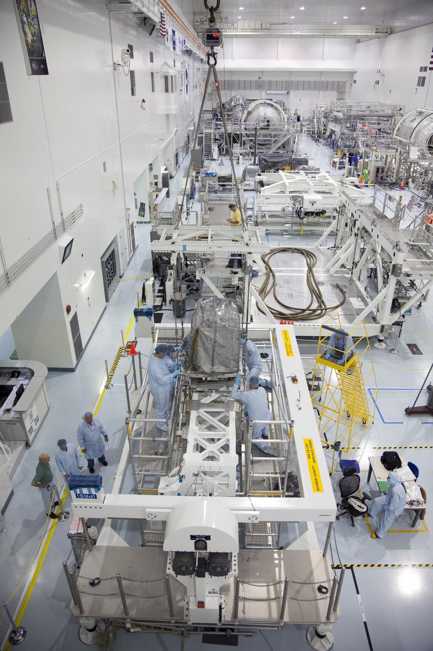 CAPE CANAVERAL, Fla. -- In the Space Station Processing Facility at NASA's Kennedy Space Center in Florida, technicians install a system that will investigate the potential for robotically refueling existing spacecraft in orbit in the Lightweight Multi-Purpose Experiment Support Structure Carrier (LMC). Called the Robotic Refueling Mission (RRM), the system is being processed to fly aboard space shuttle Atlantis in the LMC on the STS-135 mission to the International Space Station. Also going up will be the Raffaello multipurpose logistics module packed with supplies, logistics and spare parts. The mission also will return a failed ammonia pump module to help NASA better understand the failure mechanism and improve pump designs for future systems. STS-135, targeted to launch June 28, will be the 33rd flight of Atlantis, the 37th shuttle mission to the space station, and the 135th and final mission of NASA's Space Shuttle Program. For more information visit, www.nasa.gov/mission_pages/shuttle/shuttlemissions/sts135/index.html. Photo credit: NASA/Ben Smegelsky