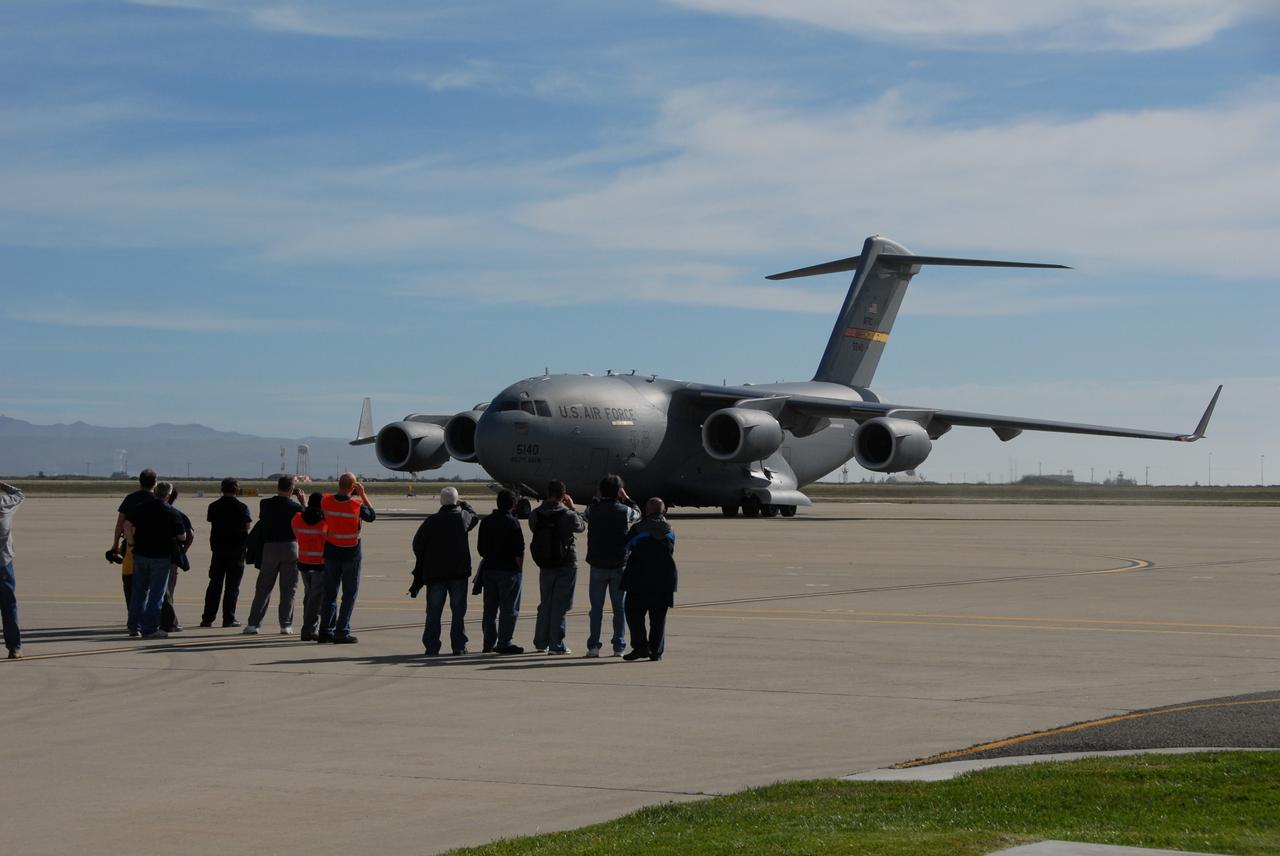 VANDENBERG AIR FORCE BASE, Calif. -- Workers at Vandenberg Air Force Base in California snap photos of the U.S. Air Force C-17 transport plane carrying the Aquarius/SAC-D spacecraft. The aircraft traveled from Campos, Brazil. Following final tests, the spacecraft will be integrated to a United Launch Alliance Delta II rocket in preparation for the targeted June launch to low Earth orbit.        Aquarius, the NASA-built primary instrument on the SAC-D spacecraft, will map global changes in salinity at the ocean's surface. Salinity is a key measurement for understanding how changes in rainfall, evaporation and the melting of freezing of ice influence ocean circulation and are linked to variations in Earth's climate. The three-year mission will provide new insights into how variations in ocean surface salinity relate to these fundamental climate processes. Photo credit: VAFB/30th Space Wing