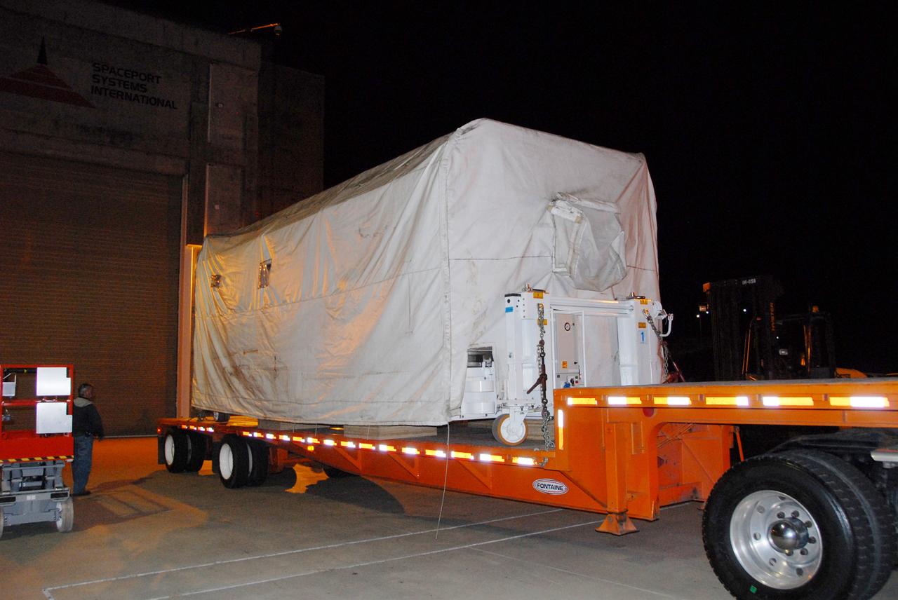 VANDENBERG AIR FORCE BASE, Calif. -- The Aquarius/SAC-D spacecraft is transported to the Spaceport Systems International processing facility at Vandenberg Air Force Base in California.  Earlier, a U.S. Air Force C-17 transport plane delivered the spacecraft from Campos, Brazil. Following final tests, the spacecraft will be integrated to a United Launch Alliance Delta II rocket in preparation for the targeted June launch to low Earth orbit.      Aquarius, the NASA-built primary instrument on the SAC-D spacecraft, will map global changes in salinity at the ocean's surface. Salinity is a key measurement for understanding how changes in rainfall, evaporation and the melting of freezing of ice influence ocean circulation and are linked to variations in Earth's climate. The three-year mission will provide new insights into how variations in ocean surface salinity relate to these fundamental climate processes. Photo credit: VAFB/30th Space Wing