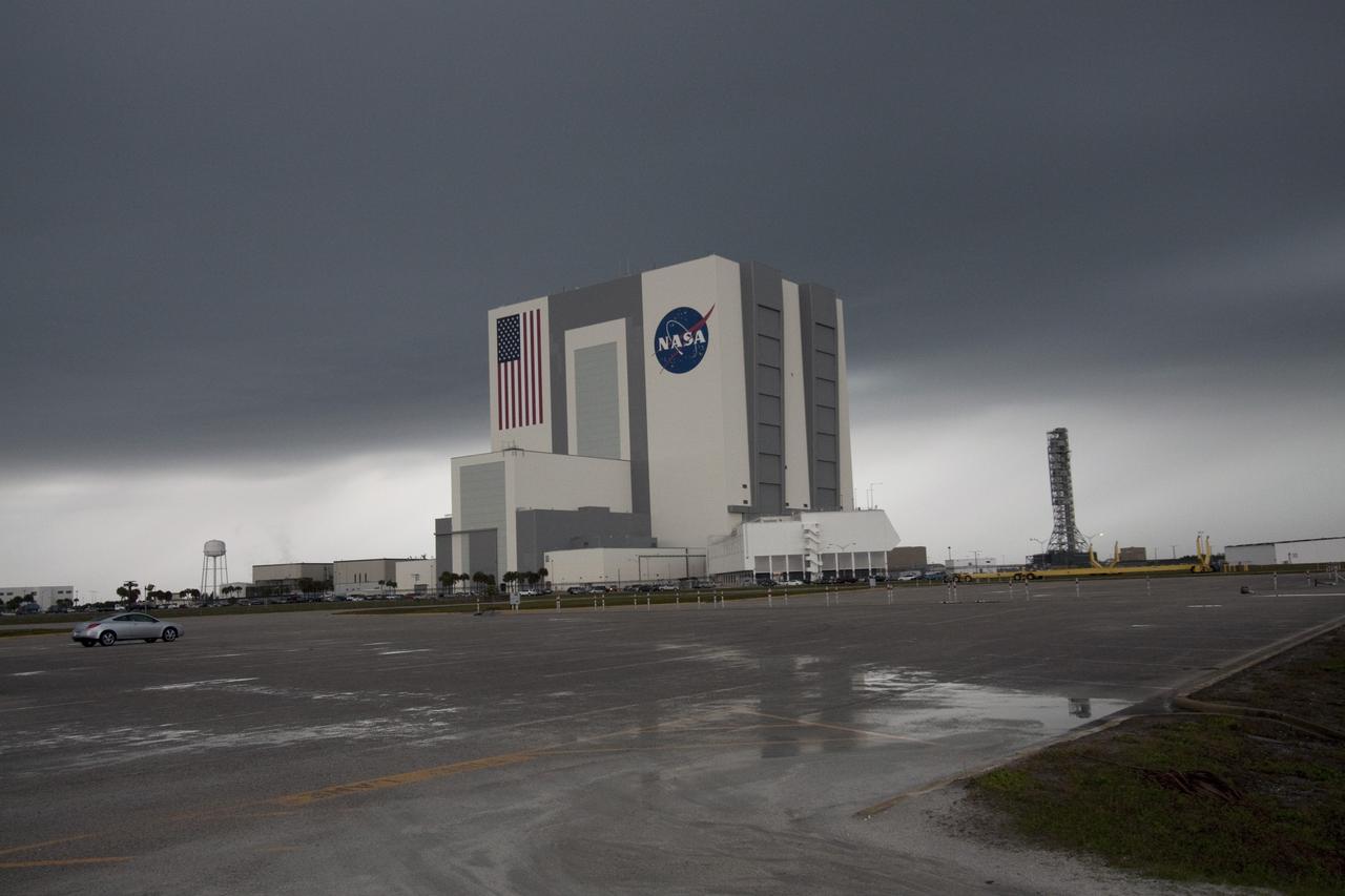 CAPE CANAVERAL, Fla. – At NASA's Kennedy Space Center in Florida, dark clouds hover over the Vehicle Assembly Building in the Launch Complex 39 area. Severe storms associated with a frontal system are moving through Central Florida, producing strong winds, heavy rain, frequent lightning and even funnel clouds. Photo credit: NASA/Jack Pfaller
