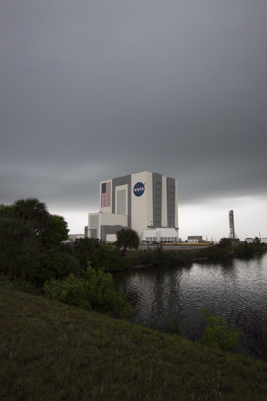 CAPE CANAVERAL, Fla. – At NASA's Kennedy Space Center in Florida, dark clouds hover over the Vehicle Assembly Building in the Launch Complex 39 area. Severe storms associated with a frontal system are moving through Central Florida, producing strong winds, heavy rain, frequent lightning and even funnel clouds. Photo credit: NASA/Jack Pfaller