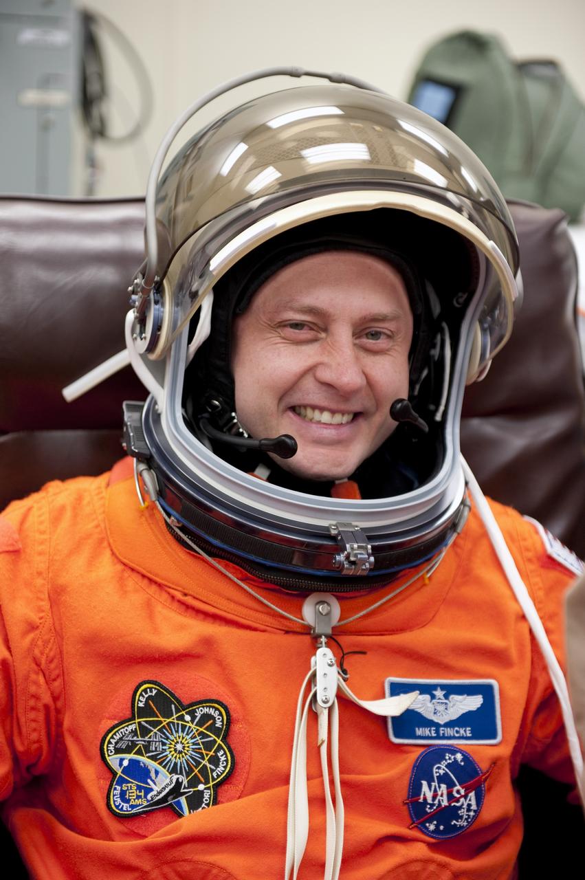 CAPE CANAVERAL, Fla. -- During a simulated launch countdown, STS-134 Mission Specialist Michael Fincke checks the fit of his helmet in the Operations and Checkout Building at NASA's Kennedy Space Center in Florida. Next, Fincke and his crewmates will walk out to the waiting Astrovan. As part of the Terminal Countdown Demonstration Test (TCDT), the crew members will ride to the pad in their silver Astrovan and strap into space shuttle Endeavour to practice the steps that will be taken on launch day. Endeavour's six crew members are targeted to launch April 19 at 7:48 p.m. EDT. They will deliver the Express Logistics Carrier-3, Alpha Magnetic Spectrometer-2 (AMS), a high-pressure gas tank, additional spare parts for the Dextre robotic helper and micrometeoroid debris shields to the International Space Station. This will be the final spaceflight for Endeavour. For more information visit, www.nasa.gov/mission_pages/shuttle/shuttlemissions/sts134/index.html. Photo credit: NASA/Kim Shiflett
