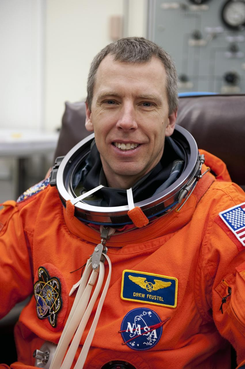 CAPE CANAVERAL, Fla. -- During a simulated launch countdown, STS-134 Mission Specialist Andrew Feustel checks the fit of his bright-orange, launch-and-entry suit in the Operations and Checkout Building at NASA's Kennedy Space Center in Florida. Next, Feustel and his crewmates will walk out to the waiting Astrovan. As part of the Terminal Countdown Demonstration Test (TCDT), the crew members will ride to the pad in their silver Astrovan and strap into space shuttle Endeavour to practice the steps that will be taken on launch day. Endeavour's six crew members are targeted to launch April 19 at 7:48 p.m. EDT. They will deliver the Express Logistics Carrier-3, Alpha Magnetic Spectrometer-2 (AMS), a high-pressure gas tank, additional spare parts for the Dextre robotic helper and micrometeoroid debris shields to the International Space Station. This will be the final spaceflight for Endeavour. For more information visit, www.nasa.gov/mission_pages/shuttle/shuttlemissions/sts134/index.html. Photo credit: NASA/Kim Shiflett