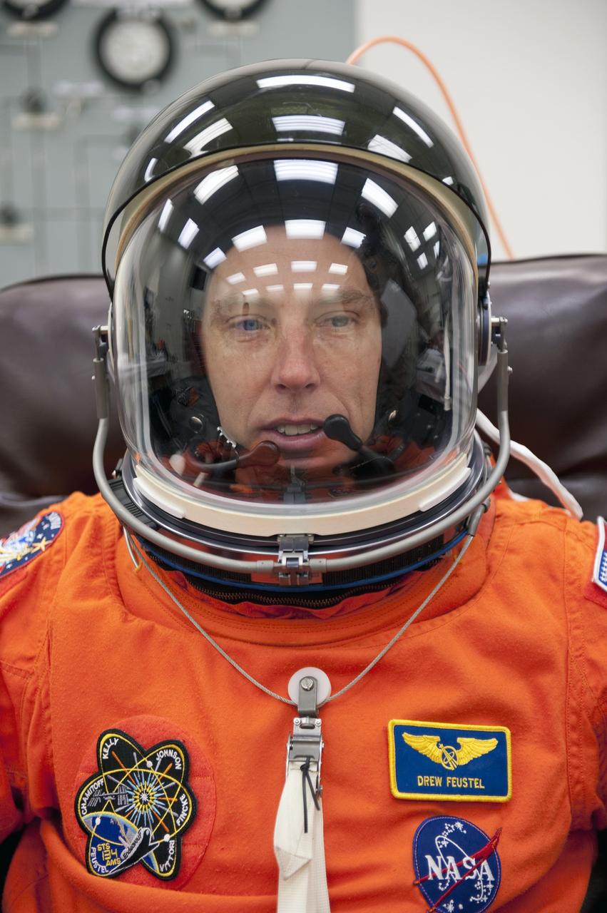 CAPE CANAVERAL, Fla. -- During a simulated launch countdown, STS-134 Mission Specialist Andrew Feustel checks the fit of his helmet in the Operations and Checkout Building at NASA's Kennedy Space Center in Florida. Next, Feustel and his crewmates will walk out to the waiting Astrovan. As part of the Terminal Countdown Demonstration Test (TCDT), the crew members will ride to the pad in their silver Astrovan and strap into space shuttle Endeavour to practice the steps that will be taken on launch day. Endeavour's six crew members are targeted to launch April 19 at 7:48 p.m. EDT. They will deliver the Express Logistics Carrier-3, Alpha Magnetic Spectrometer-2 (AMS), a high-pressure gas tank, additional spare parts for the Dextre robotic helper and micrometeoroid debris shields to the International Space Station. This will be the final spaceflight for Endeavour. For more information visit, www.nasa.gov/mission_pages/shuttle/shuttlemissions/sts134/index.html. Photo credit: NASA/Kim Shiflett