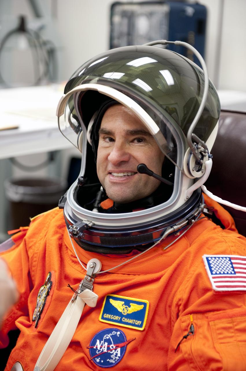 CAPE CANAVERAL, Fla. -- During a simulated launch countdown, STS-134 Mission Specialist Greg Chamitoff checks the fit of his helmet in the Operations and Checkout Building at NASA's Kennedy Space Center in Florida. Next, Chamitoff and his crewmates will walk out to the waiting Astrovan. As part of the Terminal Countdown Demonstration Test (TCDT), the crew members will ride to the pad in their silver Astrovan and strap into space shuttle Endeavour to practice the steps that will be taken on launch day. Endeavour's six crew members are targeted to launch April 19 at 7:48 p.m. EDT. They will deliver the Express Logistics Carrier-3, Alpha Magnetic Spectrometer-2 (AMS), a high-pressure gas tank, additional spare parts for the Dextre robotic helper and micrometeoroid debris shields to the International Space Station. This will be the final spaceflight for Endeavour. For more information visit, www.nasa.gov/mission_pages/shuttle/shuttlemissions/sts134/index.html. Photo credit: NASA/Kim Shiflett