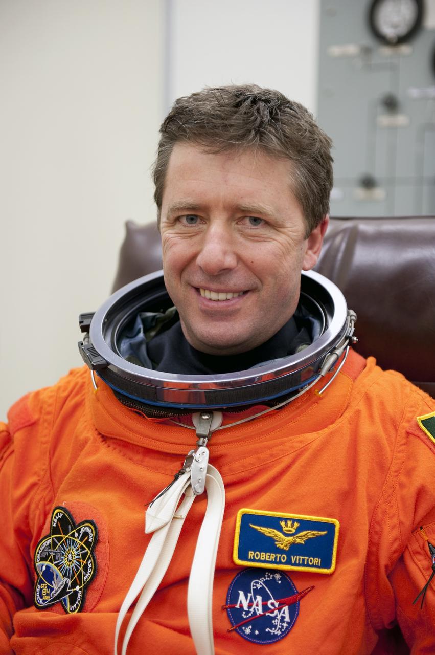 CAPE CANAVERAL, Fla. -- During a simulated launch countdown, STS-134 Mission Specialist Roberto Vittori, with the European Space Agency, checks the fit of his bright-orange, launch-and-entry suit in the Operations and Checkout Building at NASA's Kennedy Space Center in Florida. Next, Vittori and his crewmates will walk out to the waiting Astrovan. As part of the Terminal Countdown Demonstration Test (TCDT), the crew members will ride to the pad in their silver Astrovan and strap into space shuttle Endeavour to practice the steps that will be taken on launch day. Endeavour's six crew members are targeted to launch April 19 at 7:48 p.m. EDT. They will deliver the Express Logistics Carrier-3, Alpha Magnetic Spectrometer-2 (AMS), a high-pressure gas tank, additional spare parts for the Dextre robotic helper and micrometeoroid debris shields to the International Space Station. This will be the final spaceflight for Endeavour. For more information visit, www.nasa.gov/mission_pages/shuttle/shuttlemissions/sts134/index.html. Photo credit: NASA/Kim Shiflett