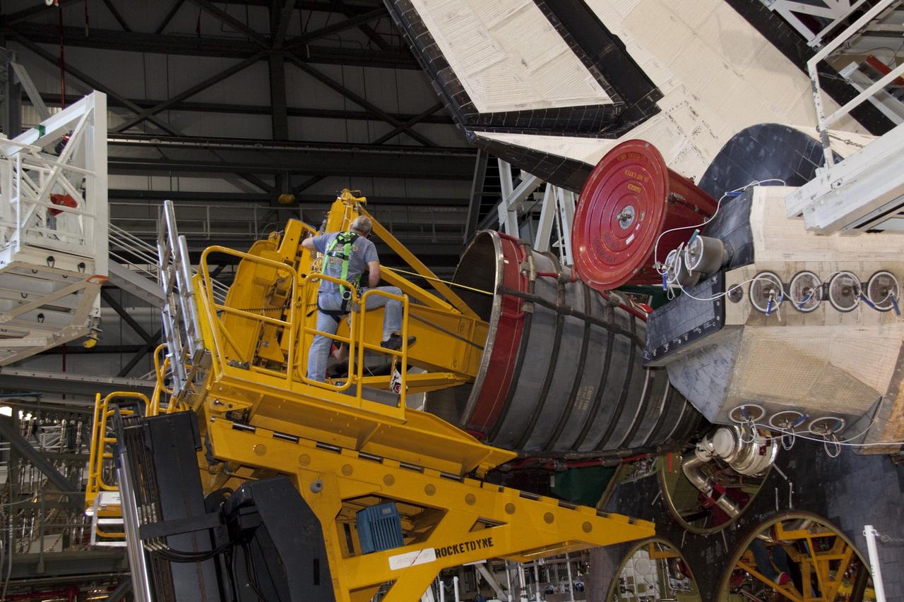 CAPE CANAVERAL, Fla. - Technicians carefully remove main engine No. 1 from space shuttle Discovery using a specially designed engine installer, called a Hyster forklift. The work is taking place in Orbiter Processing Facility-2 at NASA's Kennedy Space Center in Florida. The removal is part of Discovery's transition and retirement processing. Work performed on Discovery is expected to help rocket designers build next-generation spacecraft and prepare the shuttle for future public display.    Photo credit: NASA/Jack Pfaller