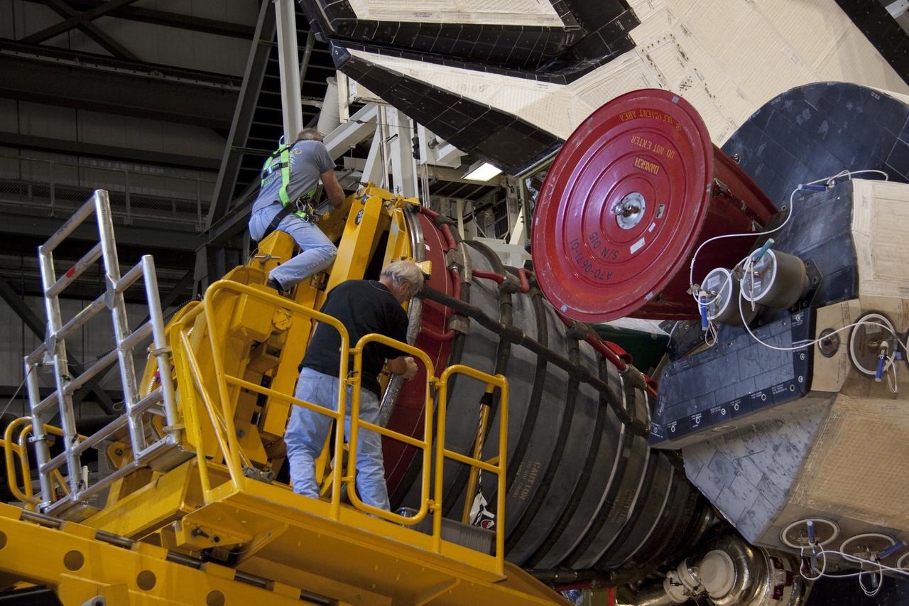 CAPE CANAVERAL, Fla. - Technicians carefully remove main engine No. 1 from space shuttle Discovery using a specially designed engine installer, called a Hyster forklift. The work is taking place in Orbiter Processing Facility-2 at NASA's Kennedy Space Center in Florida. The removal is part of Discovery's transition and retirement processing. Work performed on Discovery is expected to help rocket designers build next-generation spacecraft and prepare the shuttle for future public display.    Photo credit: NASA/Jack Pfaller