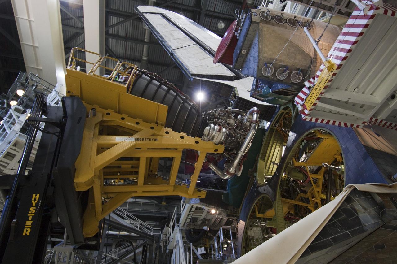 CAPE CANAVERAL, Fla. - Technicians complete the removal of main engine No. 1 from space shuttle Discovery using a specially designed engine installer, called a Hyster forklift. The work is taking place in Orbiter Processing Facility-2 at NASA's Kennedy Space Center in Florida. The removal is part of Discovery's transition and retirement processing. Work performed on Discovery is expected to help rocket designers build next-generation spacecraft and prepare the shuttle for future public display.    Photo credit: NASA/Jack Pfaller