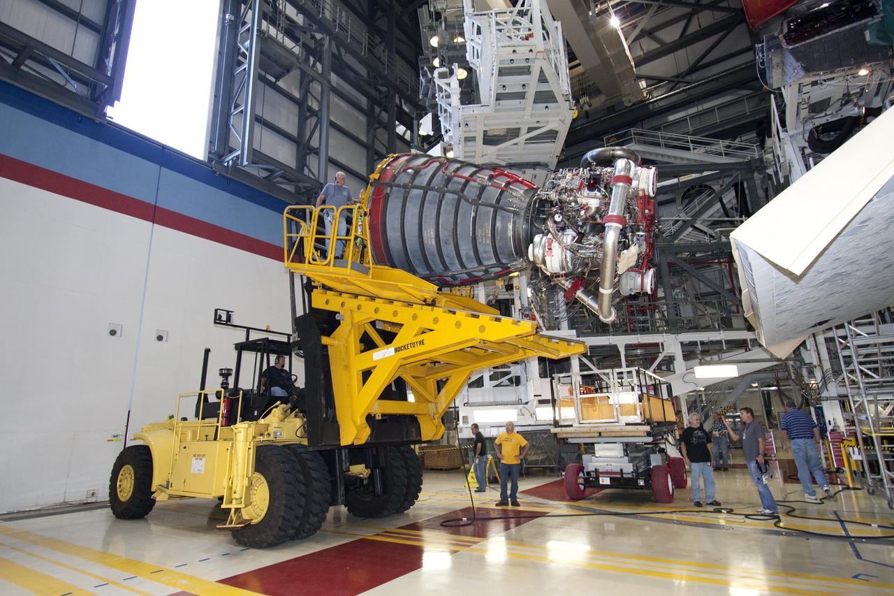 CAPE CANAVERAL, Fla. - Technicians complete the removal of main engine No. 1 from space shuttle Discovery using a specially designed engine installer, called a Hyster forklift. The work is taking place in Orbiter Processing Facility-2 at NASA's Kennedy Space Center in Florida. The removal is part of Discovery's transition and retirement processing. Work performed on Discovery is expected to help rocket designers build next-generation spacecraft and prepare the shuttle for future public display.    Photo credit: NASA/Jack Pfaller