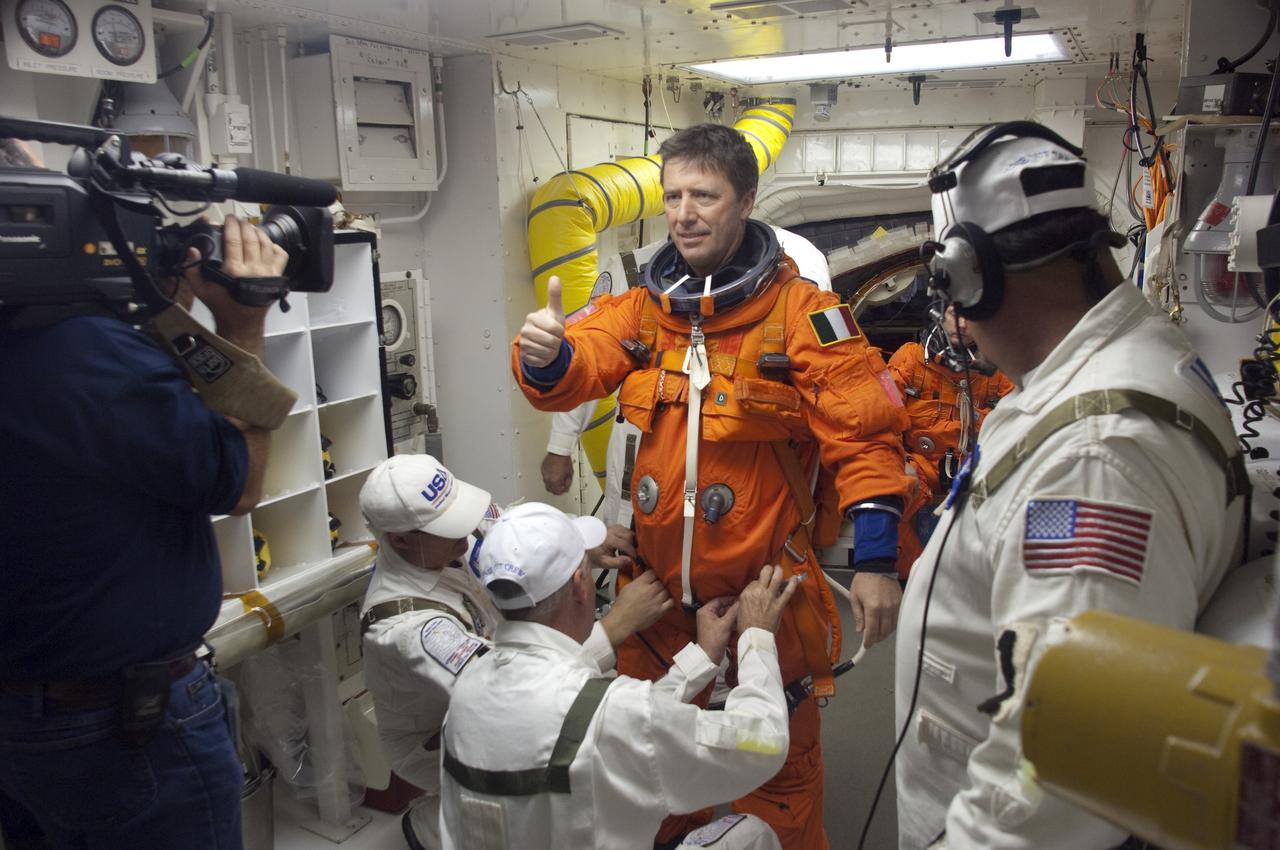 CAPE CANAVERAL, Fla. -- STS-134 Mission Specialist Roberto Vittori, with the European Space Agency, gives a thumbs-up in the White Room of Launch Pad 39A at NASA's Kennedy Space Center in Florida. The Closeout Crew is helping Vitorri put on the parachute for his launch-and-entry suit before he boards space shuttle Endeavour during the Terminal Countdown Demonstration Test (TCDT). TCDT includes practicing the final hours of a real launch day when astronauts put on their launch-and-entry suits, ride to the pad in the Astrovan and strap into the shuttle.    Endeavour's six crew members are targeted to launch April 19 at 7:48 p.m. EDT. They will deliver the Express Logistics Carrier-3, Alpha Magnetic Spectrometer-2 (AMS), a high-pressure gas tank, additional spare parts for the Dextre robotic helper and micrometeoroid debris shields to the International Space Station. This will be the final spaceflight for Endeavour. For more information visit, www.nasa.gov/mission_pages/shuttle/shuttlemissions/sts134/index.html. Photo credit: NASA/Kevin O'Connell